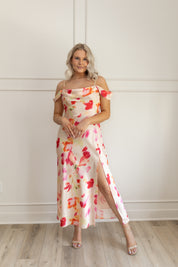 Model wearing off-the-shoulder floral midi dress with pink and red watercolor print