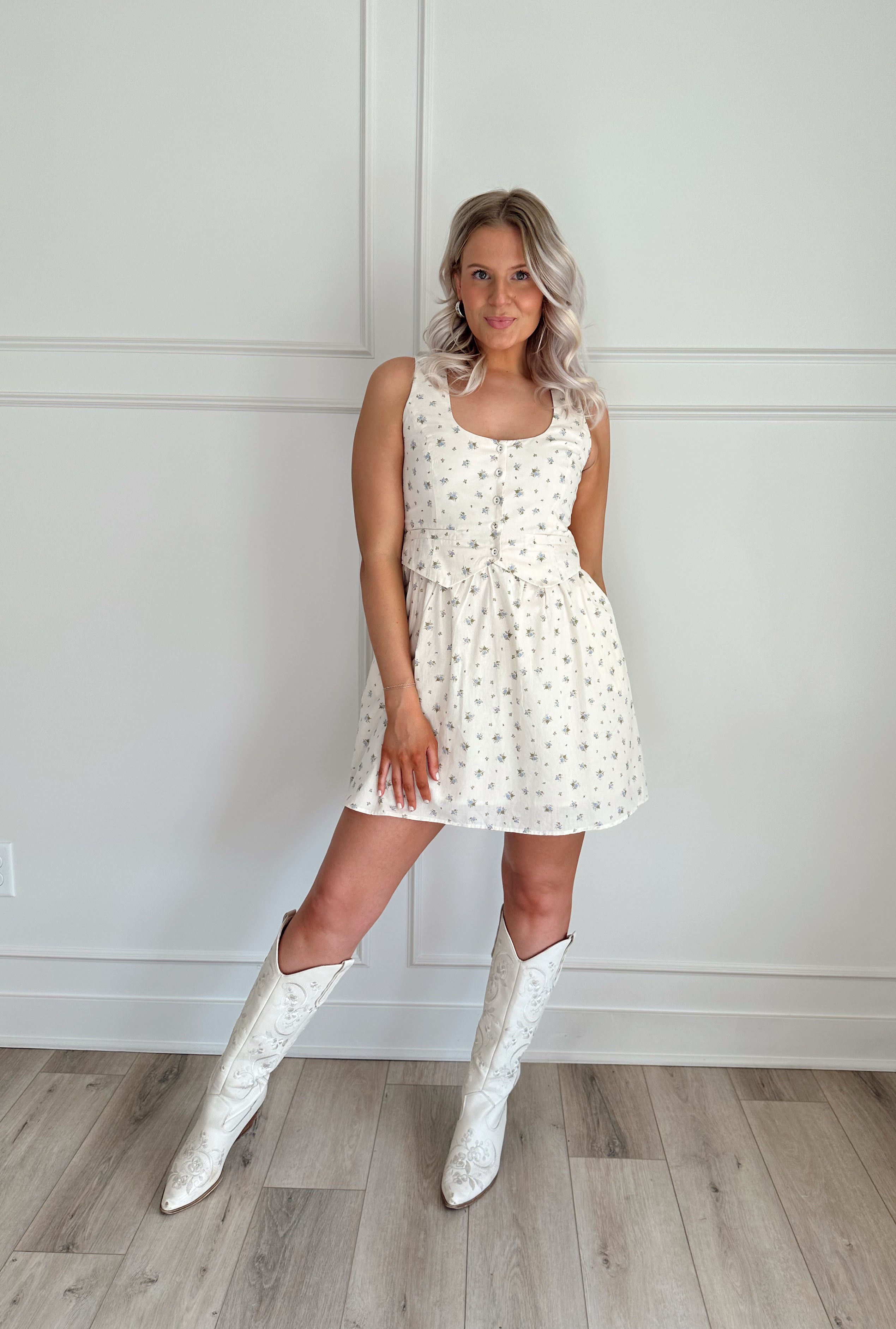 Floral babydoll mini dress with a button-up front and fitted waist.