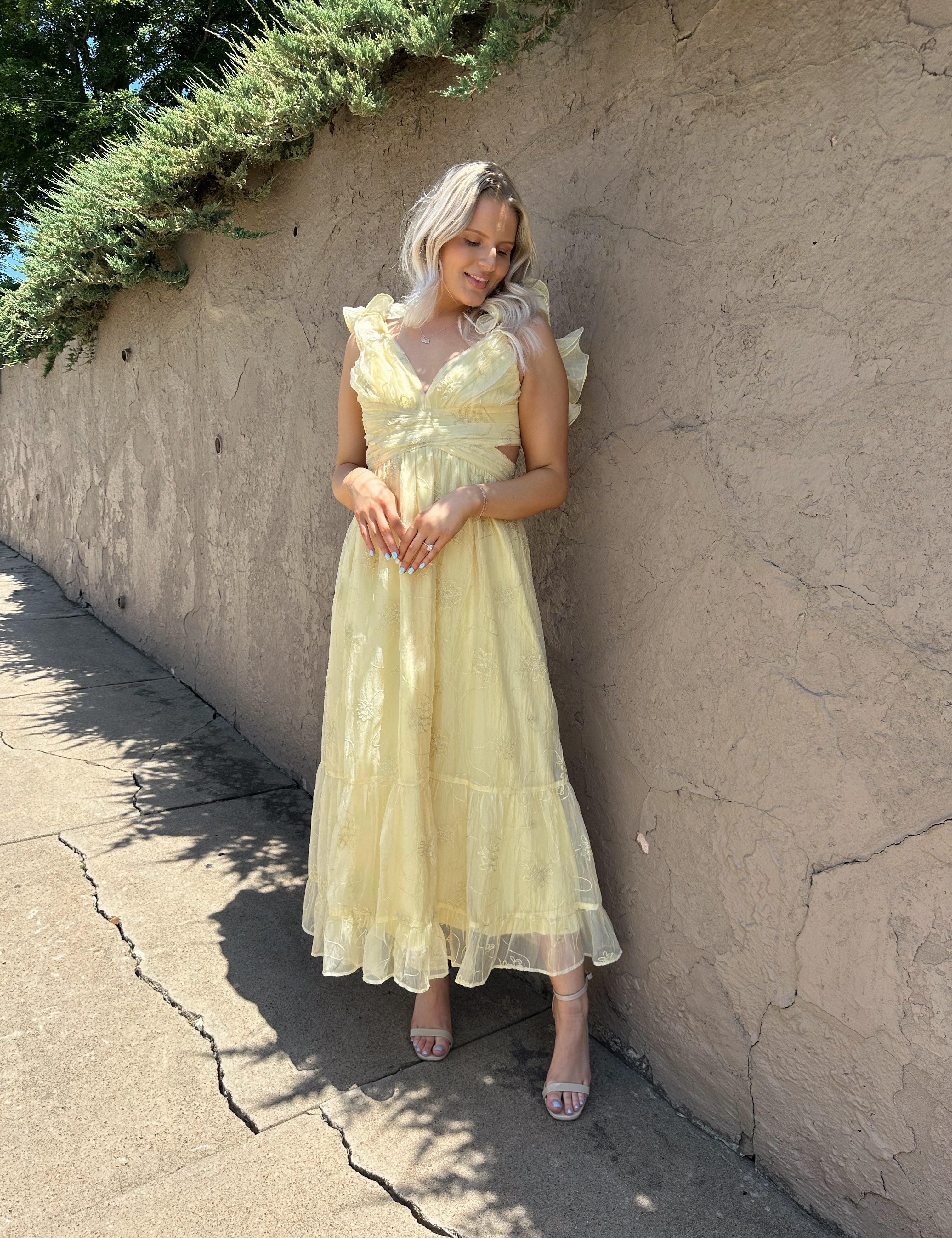 Light yellow midi dress with lace up corset back, and embroidery detailing. 
