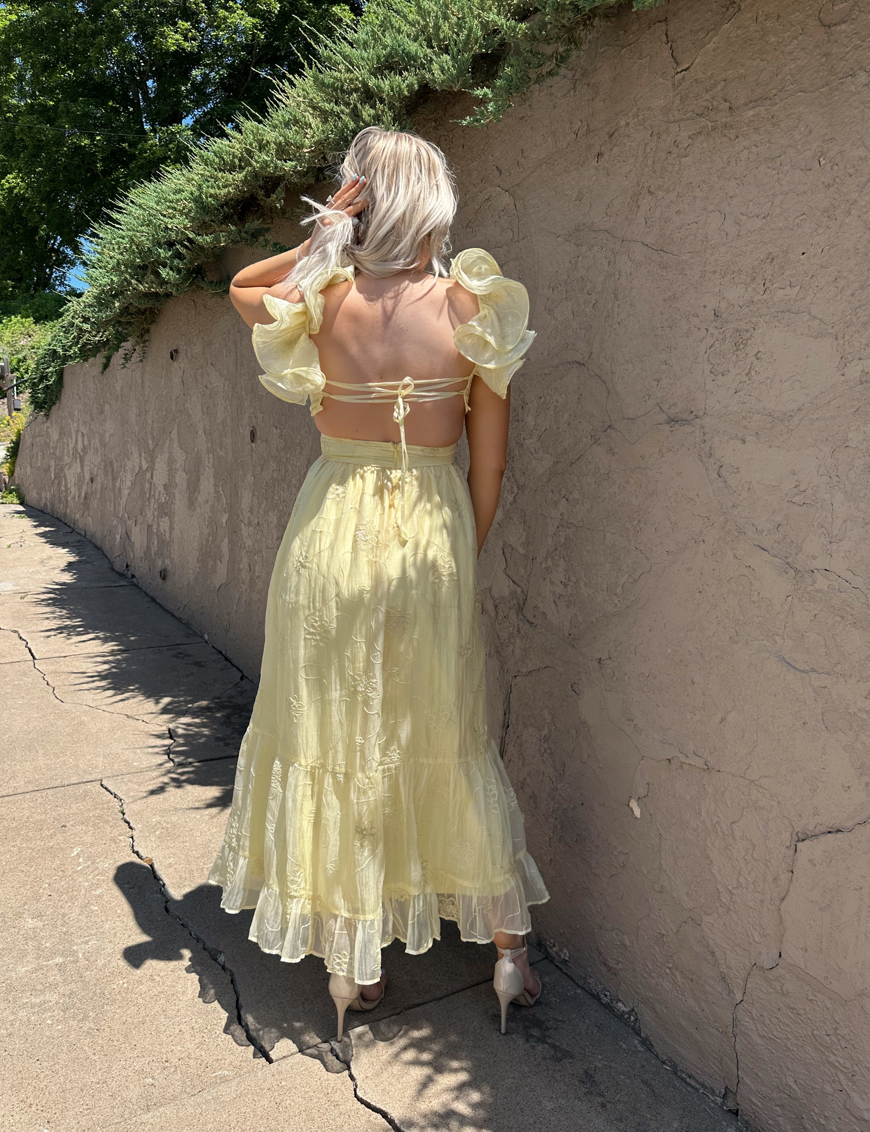 Light yellow midi dress with lace up corset back, and embroidery detailing. 