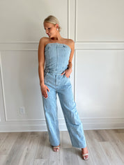 Light wash denim wide leg jumpsuit with functional pockets.