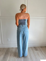 Light wash denim wide leg jumpsuit with functional pockets.