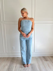 Light wash denim wide leg jumpsuit with functional pockets.