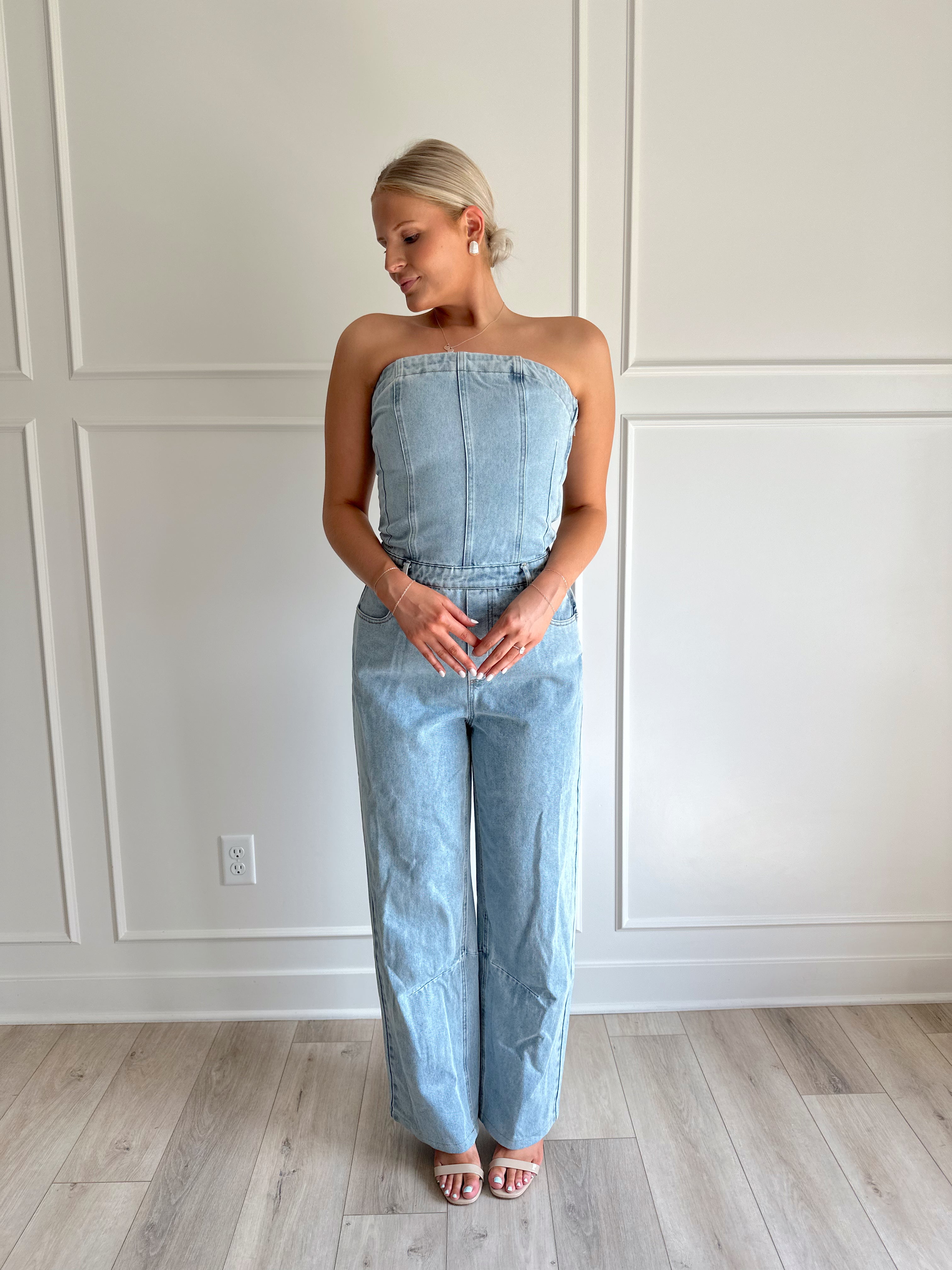 Light wash denim wide leg jumpsuit with functional pockets.