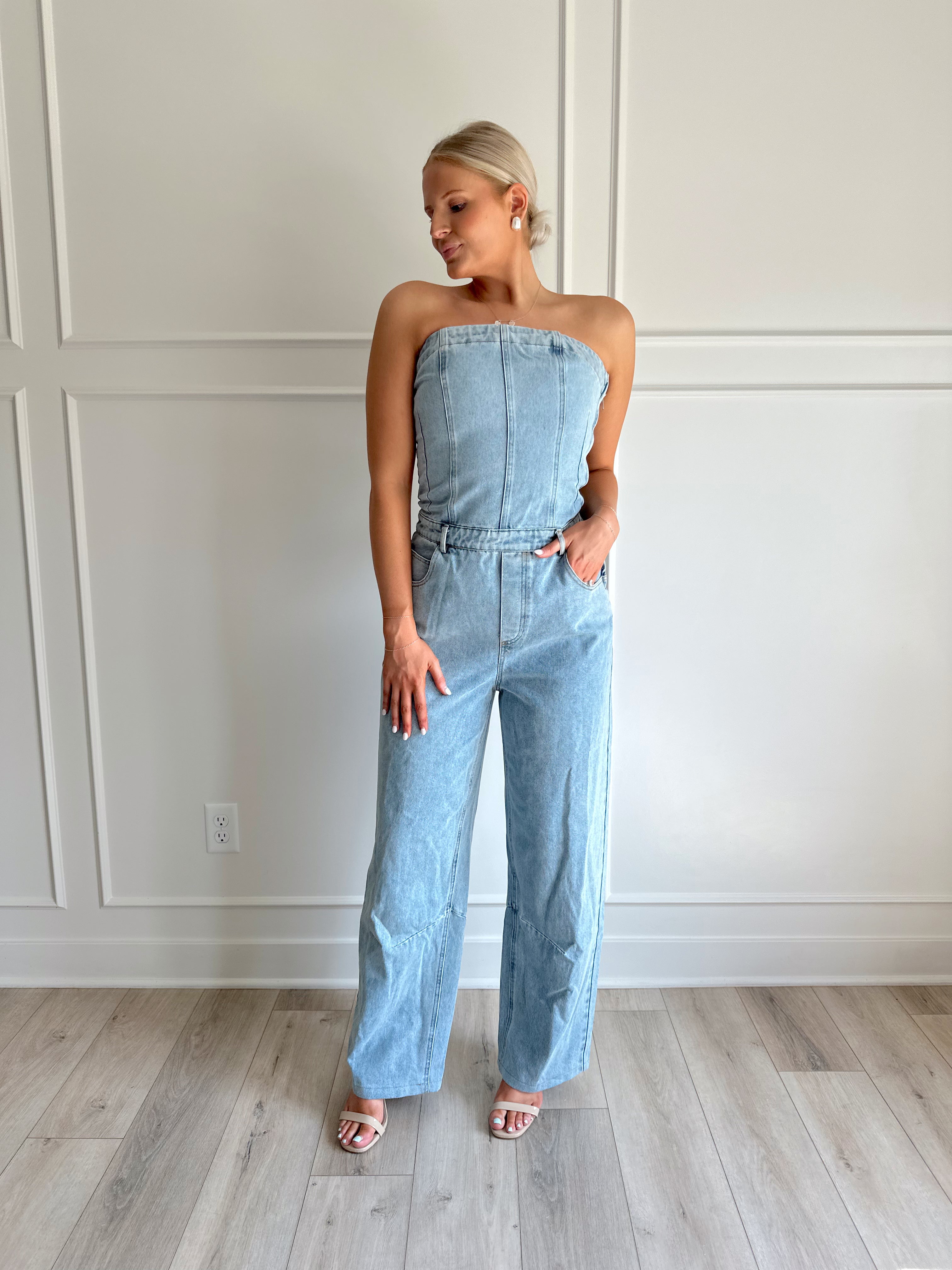 Light wash denim wide leg jumpsuit with functional pockets.