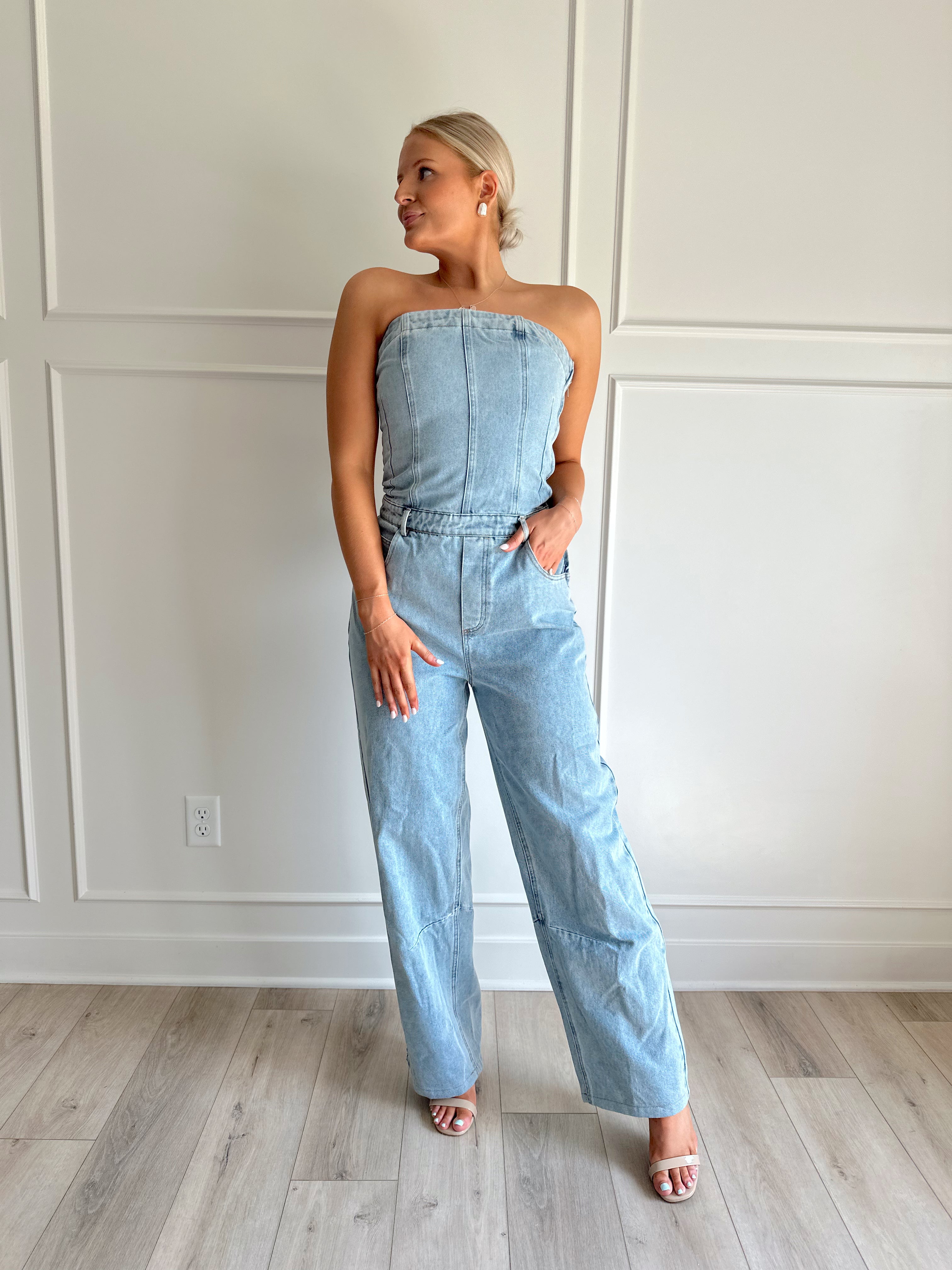 Light wash denim wide leg jumpsuit with functional pockets.