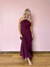 Burgundy formal maxi dress with ruffle detailing and slit up the front. 