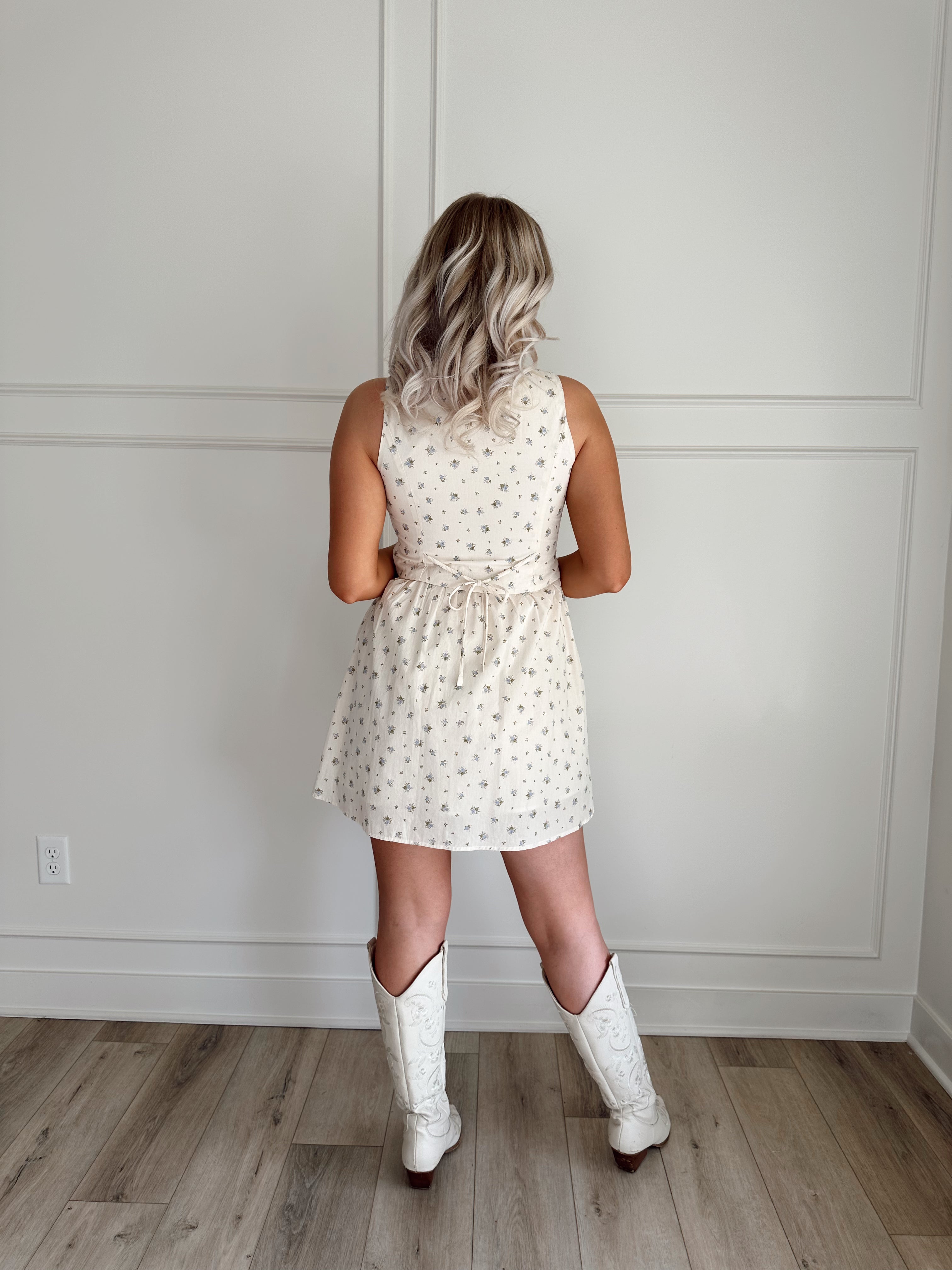 Floral babydoll mini dress with a button-up front and fitted waist.