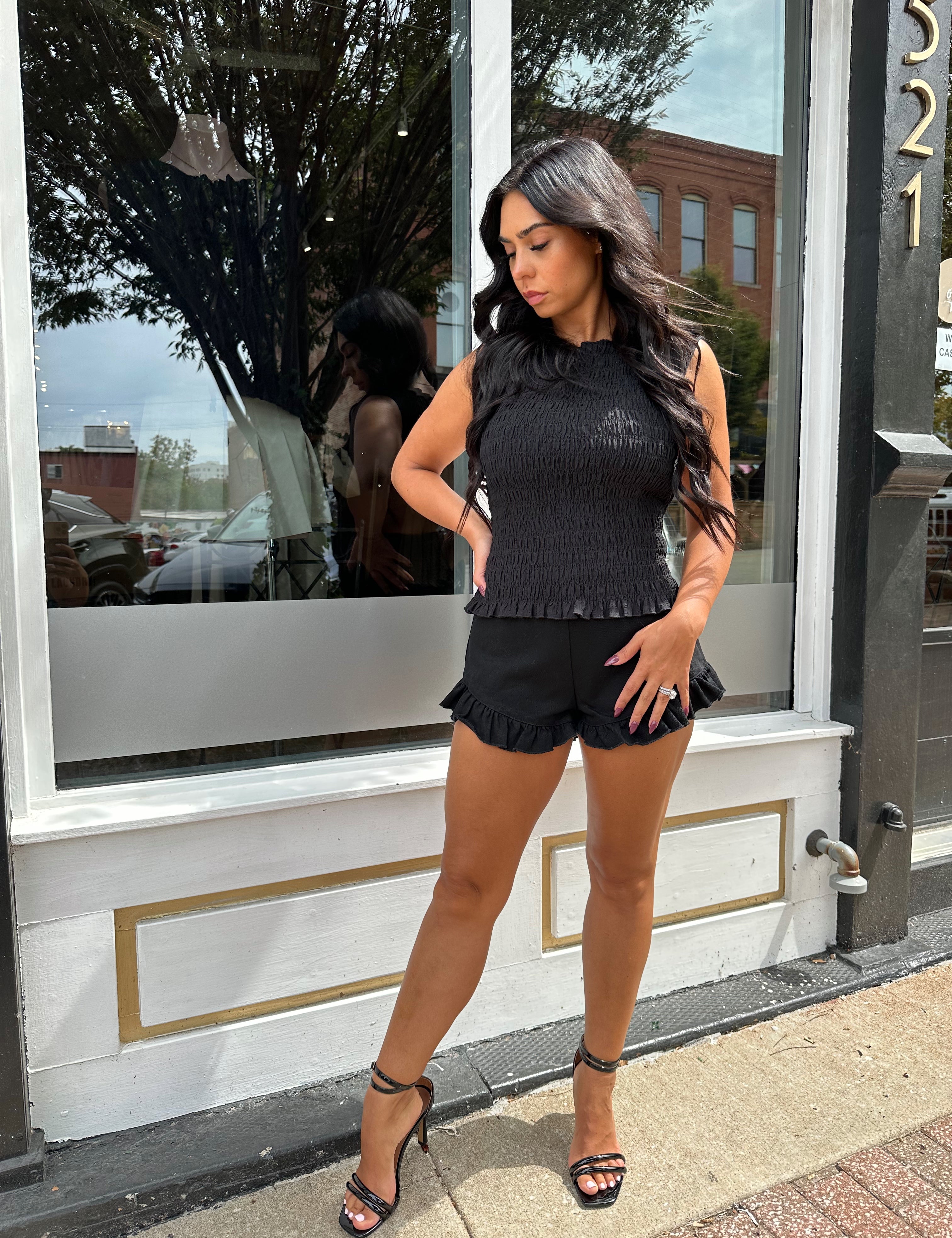 Woman wearing black denim micro short. 