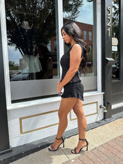 Woman wearing black denim micro short. 