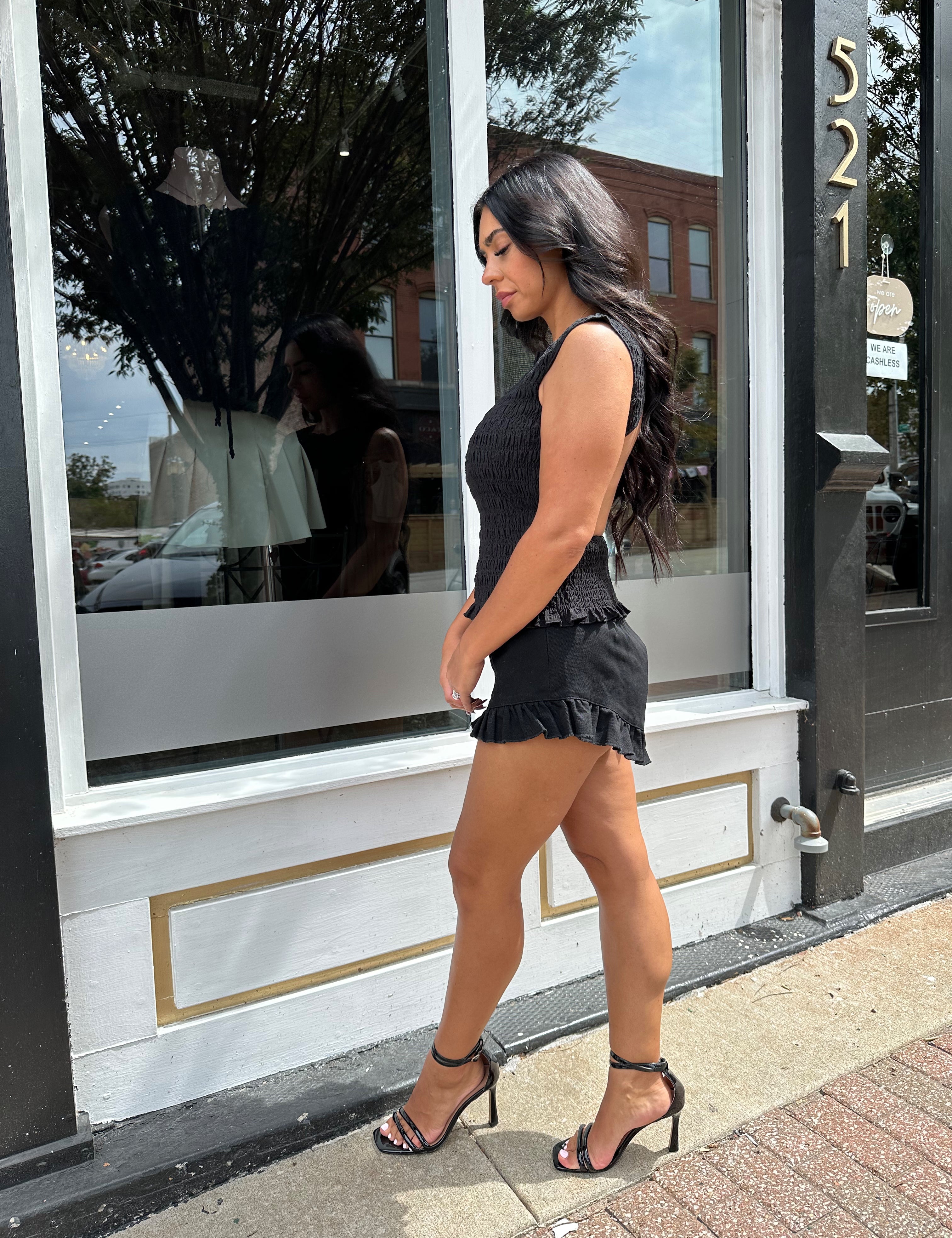 Woman wearing black denim micro short. 