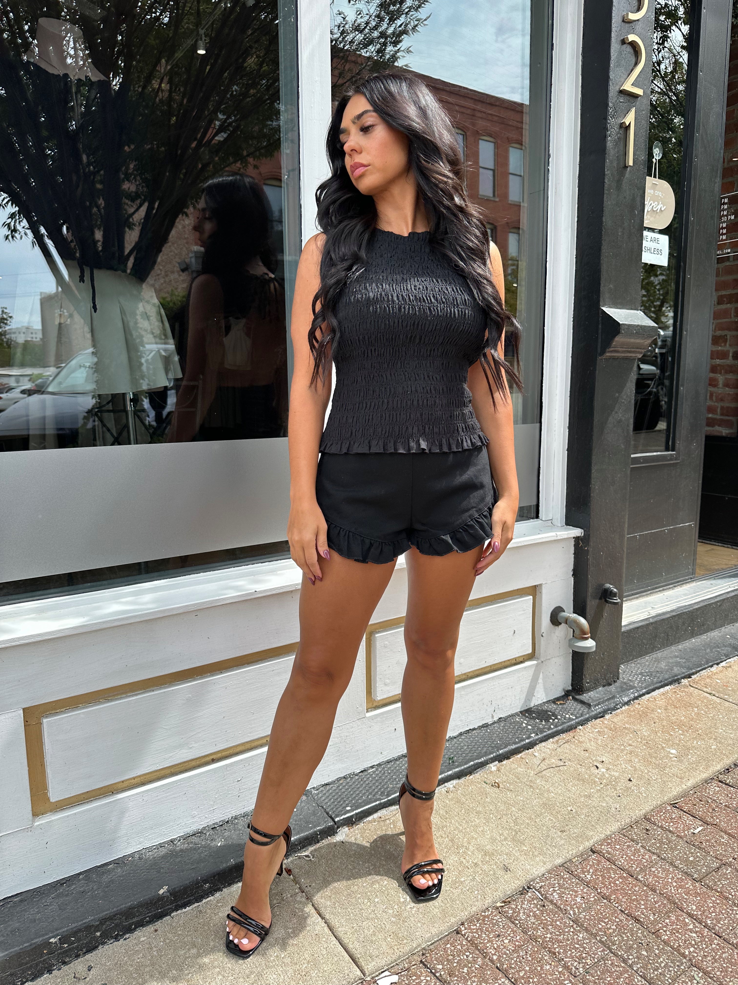 Woman wearing black denim micro short. 