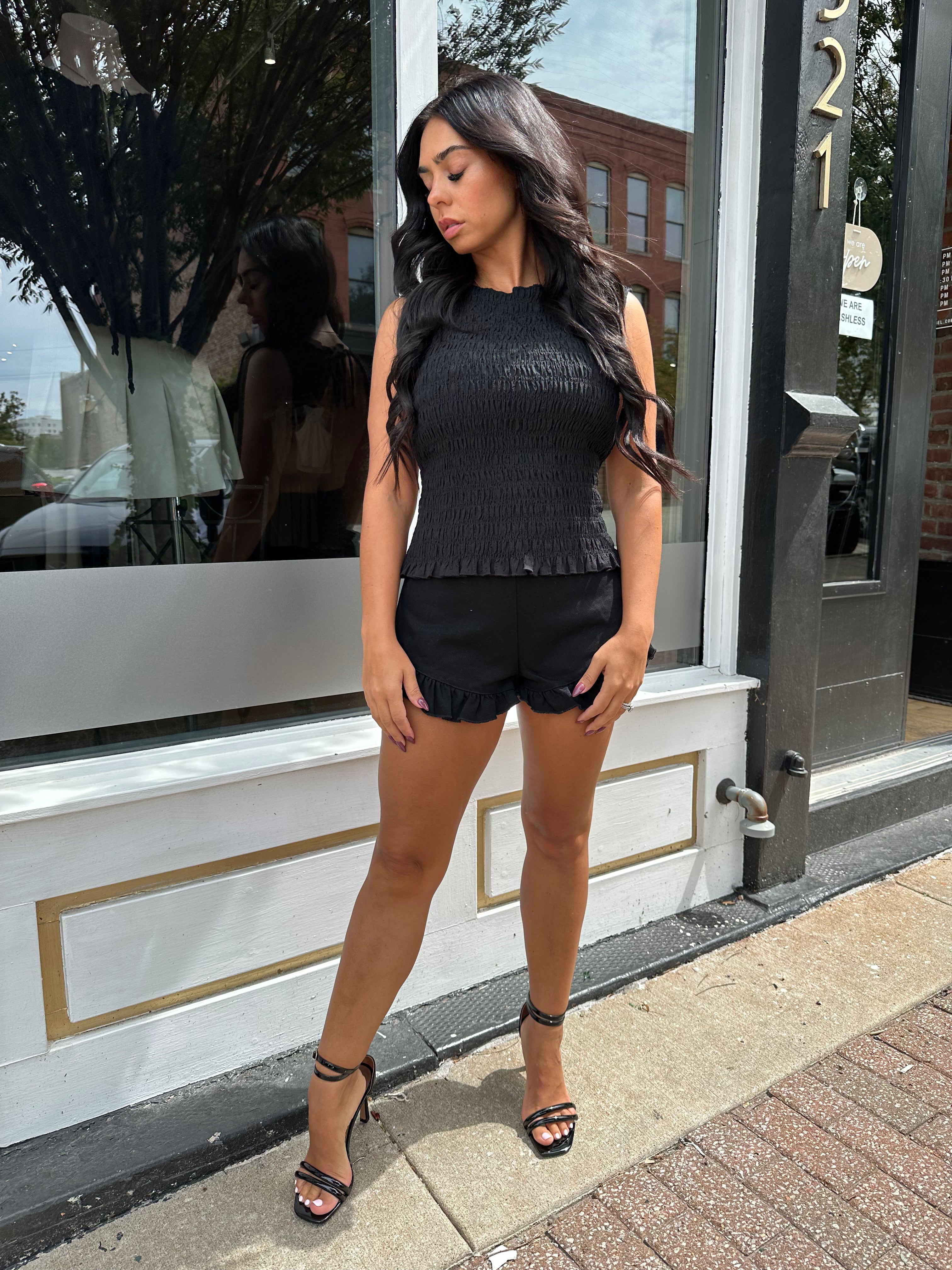 Woman wearing black denim micro short. 