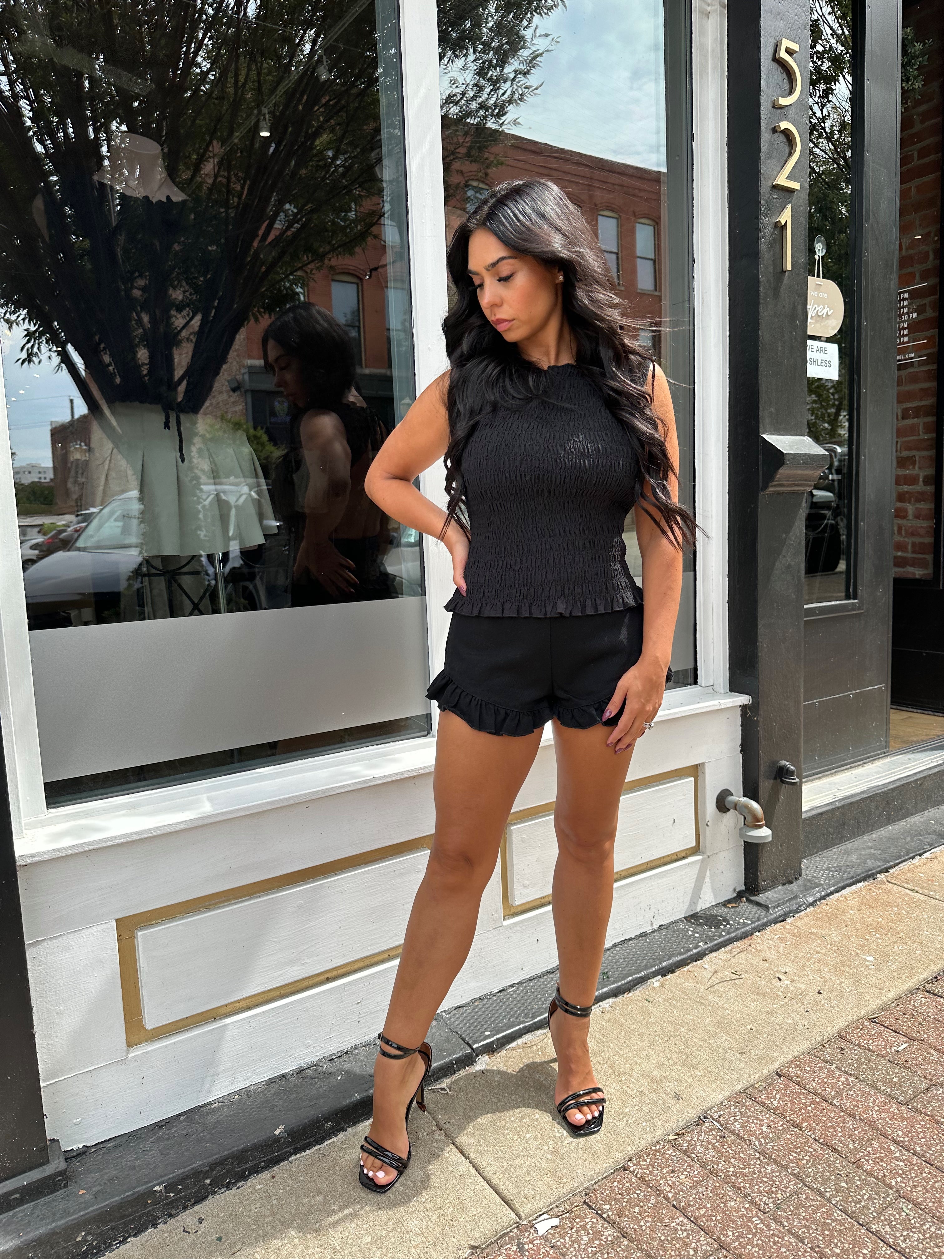 Woman wearing black denim micro short. 