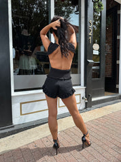 Woman wearing black denim micro short. 