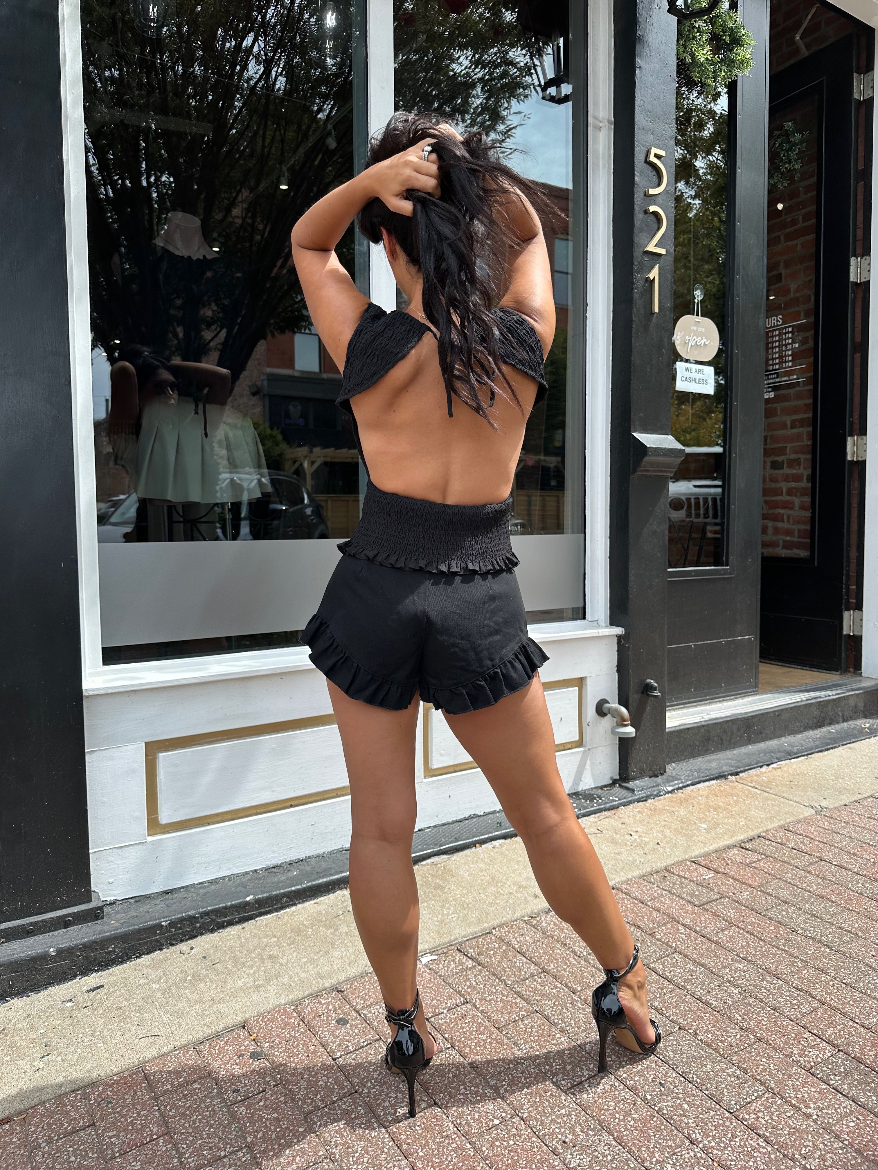 Woman wearing black denim micro short. 