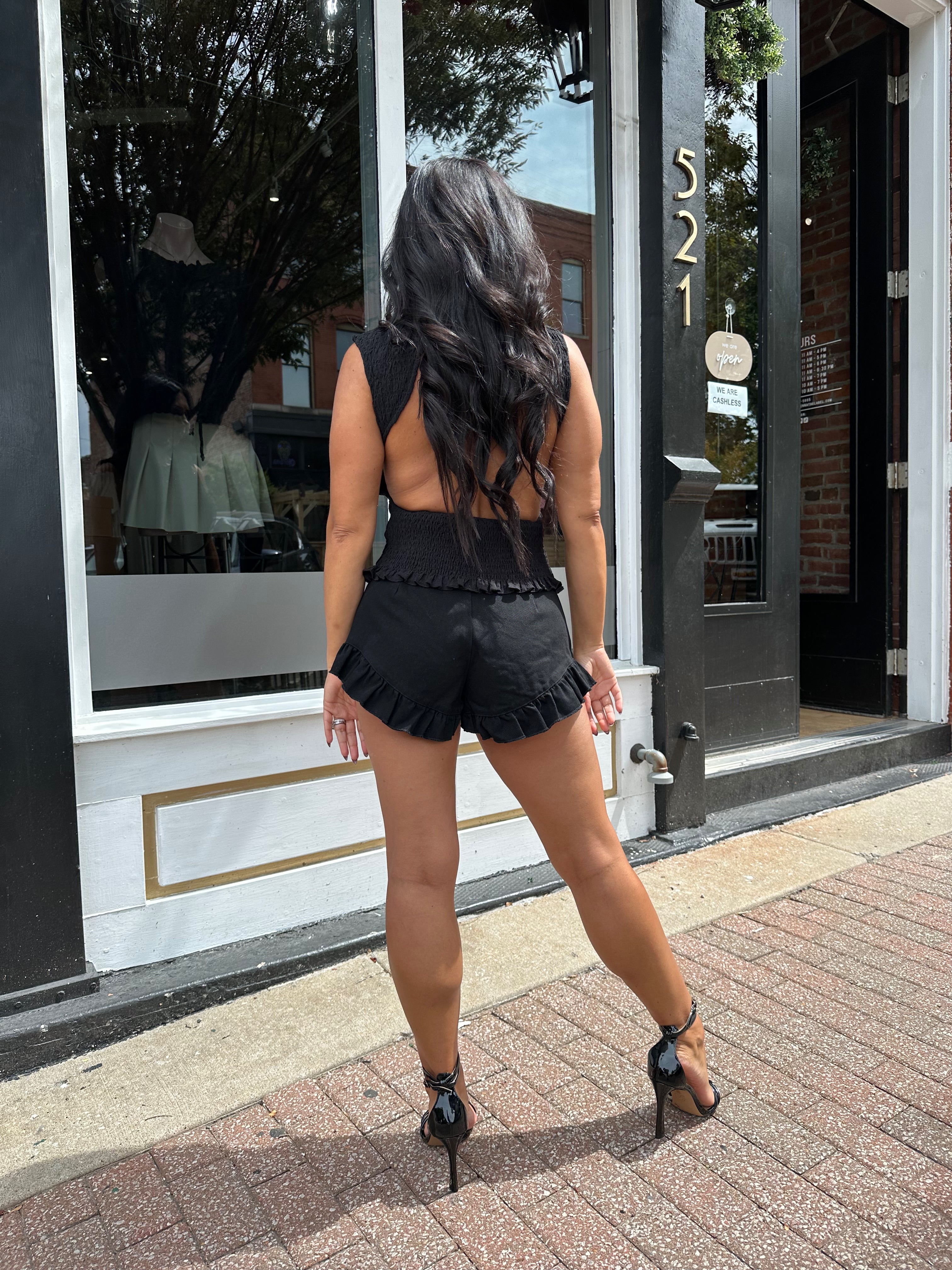 Woman wearing black denim micro short. 