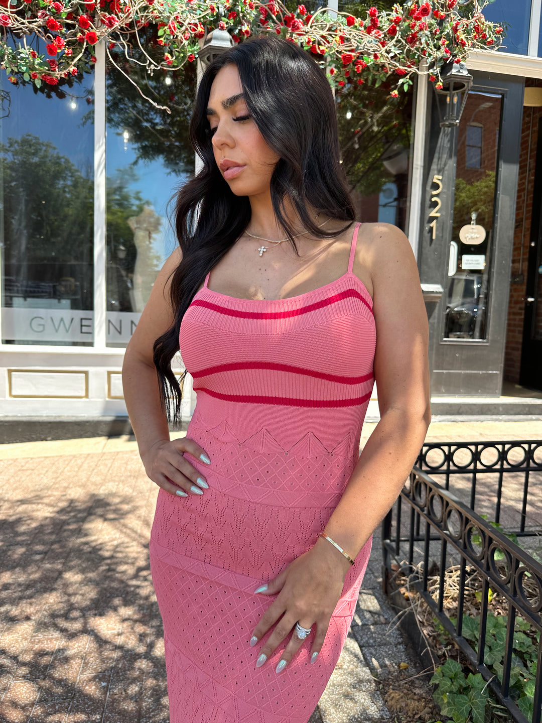 Woman wearing pink contrast knit midi dress with adjustable spaghetti traps.