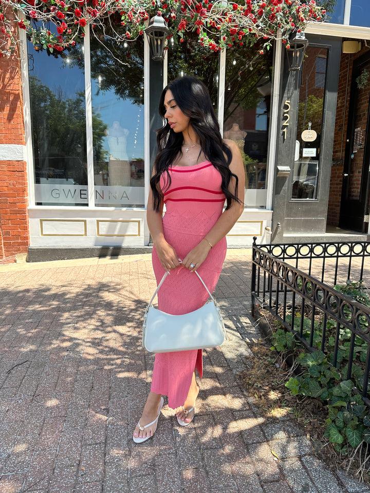 Woman wearing pink contrast knit midi dress with adjustable spaghetti traps.
