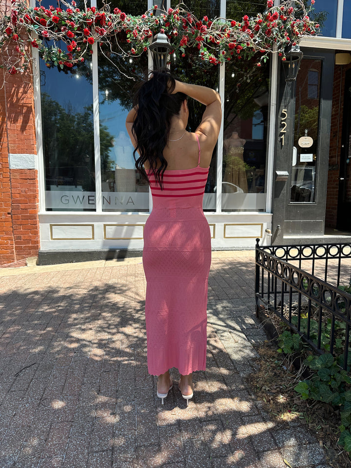 Woman wearing pink contrast knit midi dress with adjustable spaghetti traps.