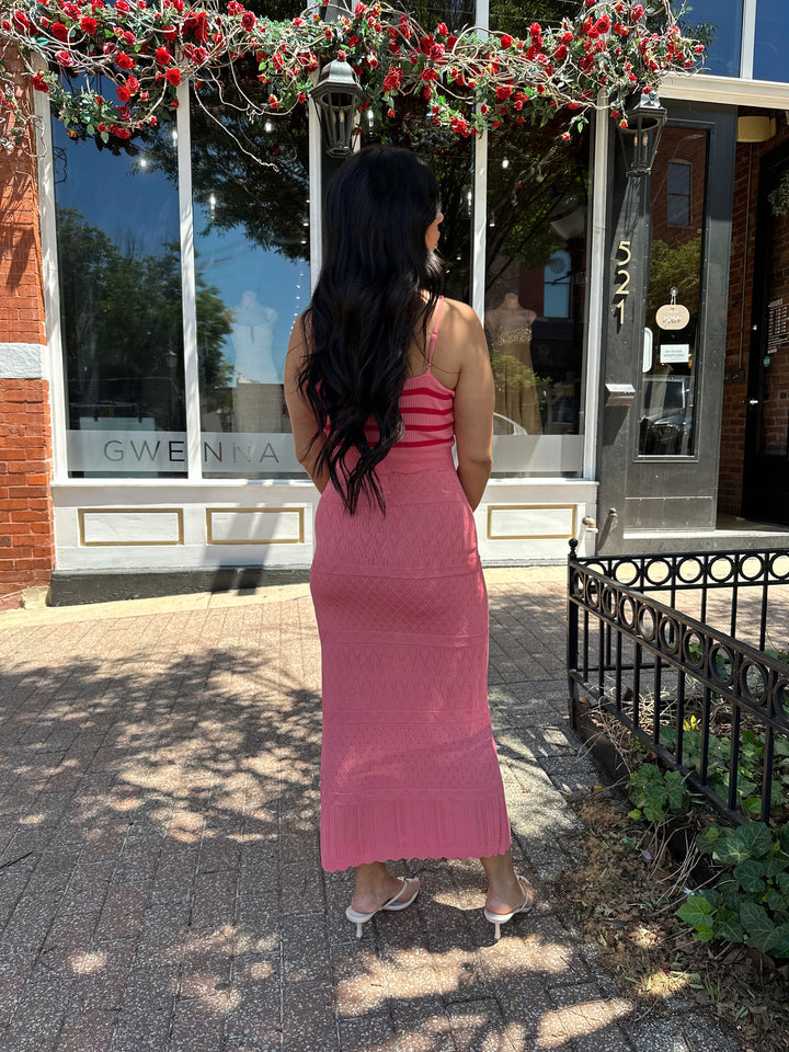 Woman wearing pink contrast knit midi dress with adjustable spaghetti traps.