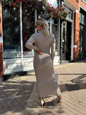Woman wearing mocha long sleeve knit sweater dress with tie front detail. 