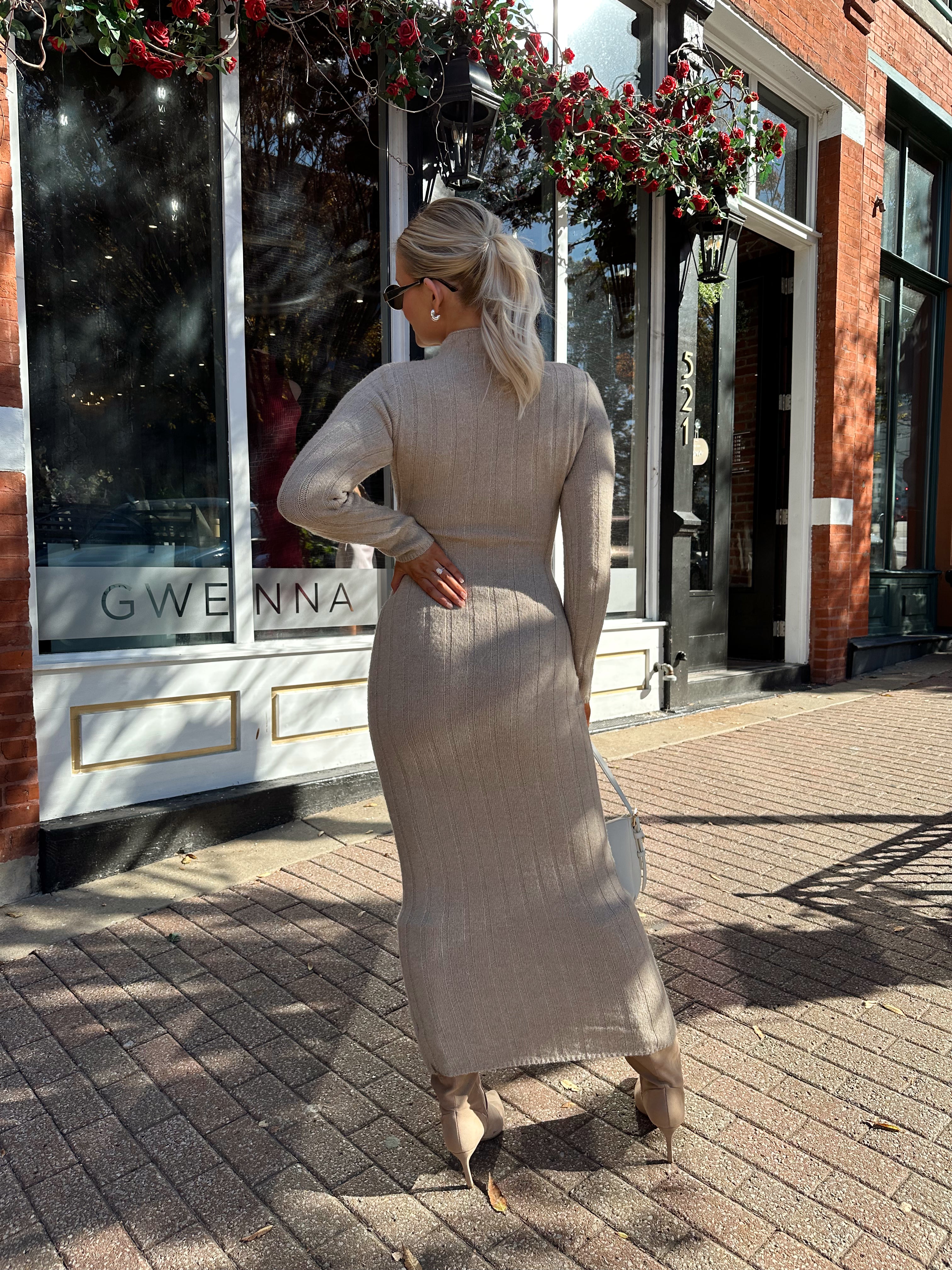 Woman wearing mocha long sleeve knit sweater dress with tie front detail. 