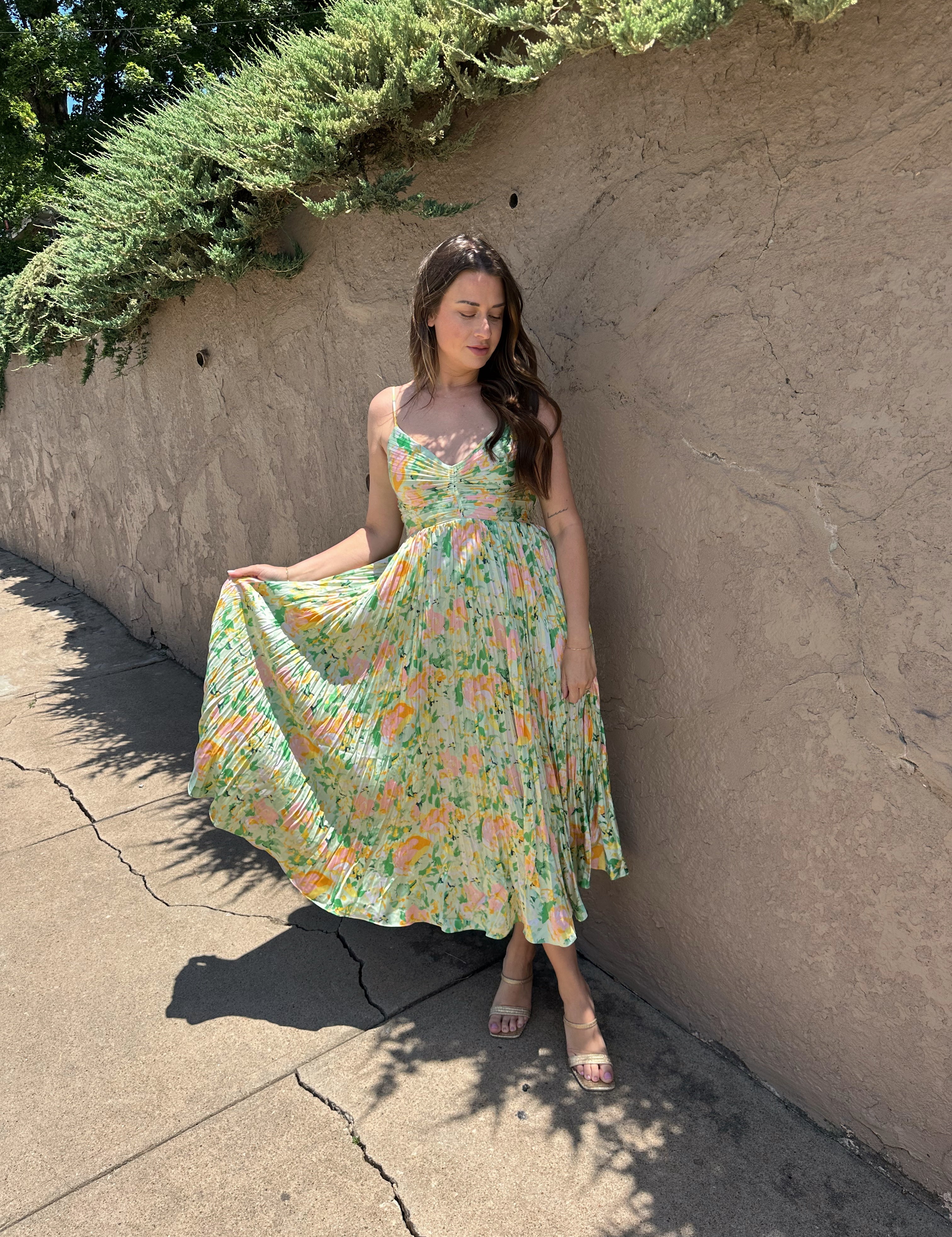Light green floral pleated midi dress with adjustable spaghetti straps.