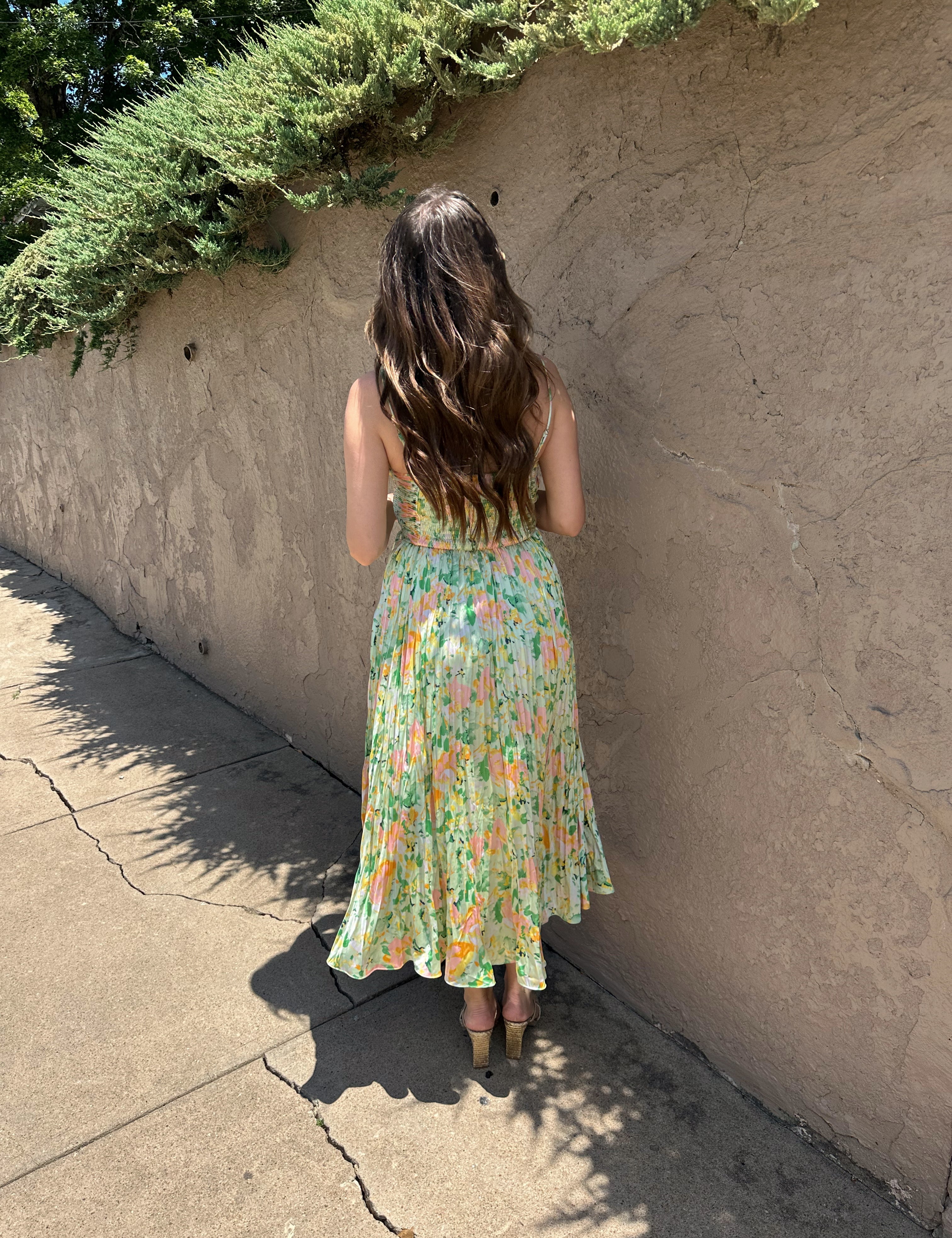 Light green floral pleated midi dress with adjustable spaghetti straps.