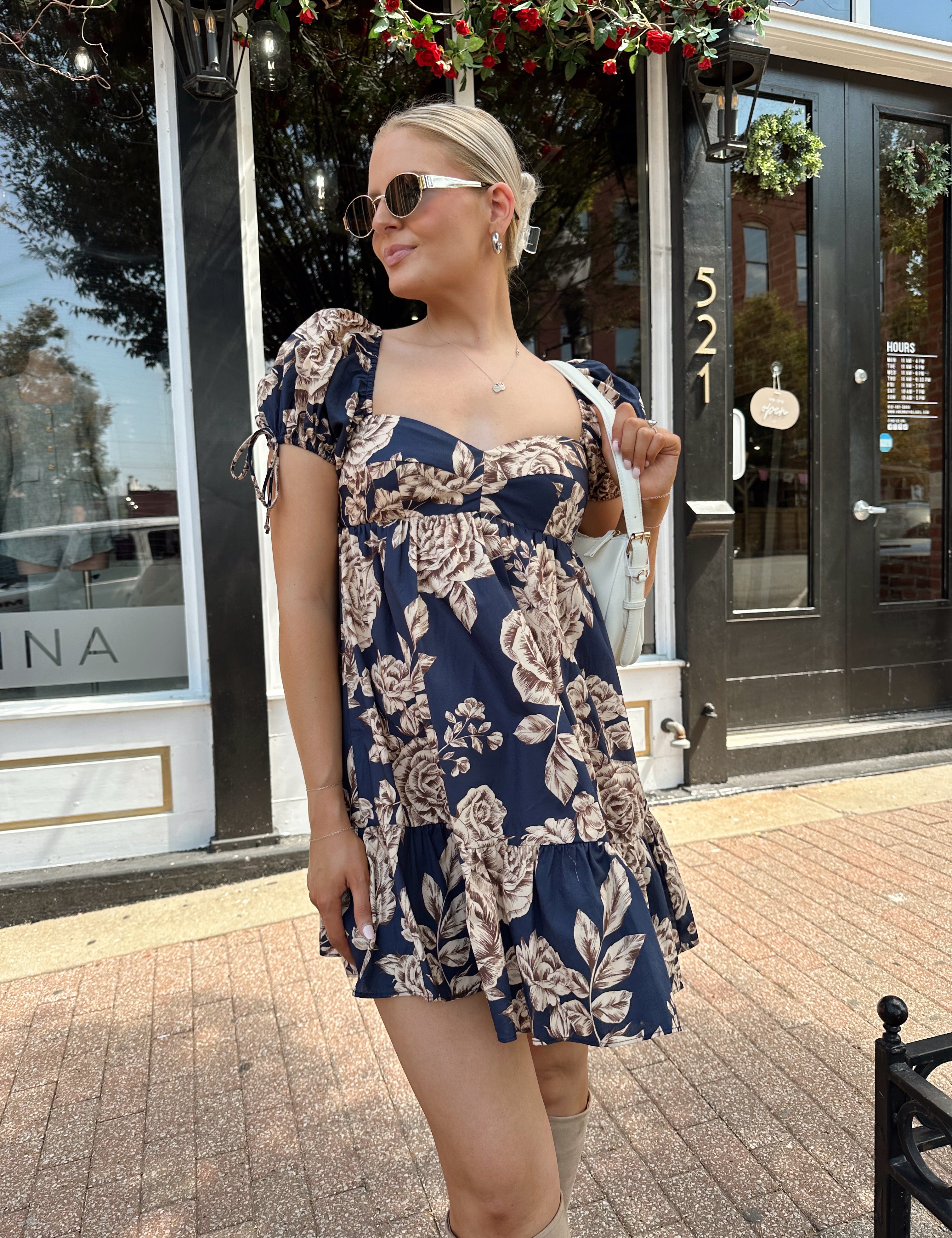 Navy blue floral baby doll mini dress with brown floral pattern. 