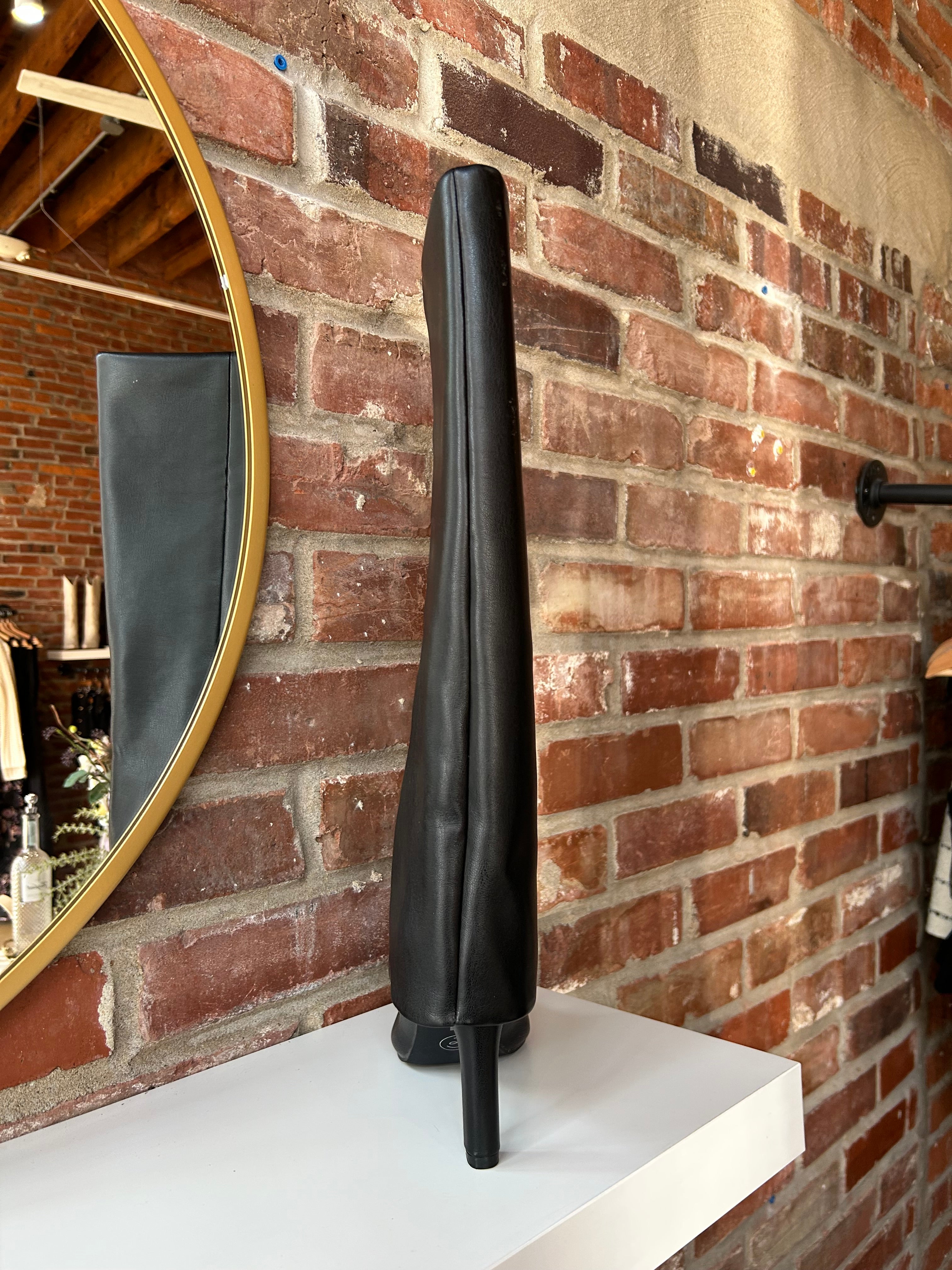 Black leather fold over knee boot with pointed toed and 3 1/4 inch heel.