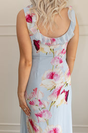 Blue maxi dress with pink floral pattern. Slit with a ruffle detail. 