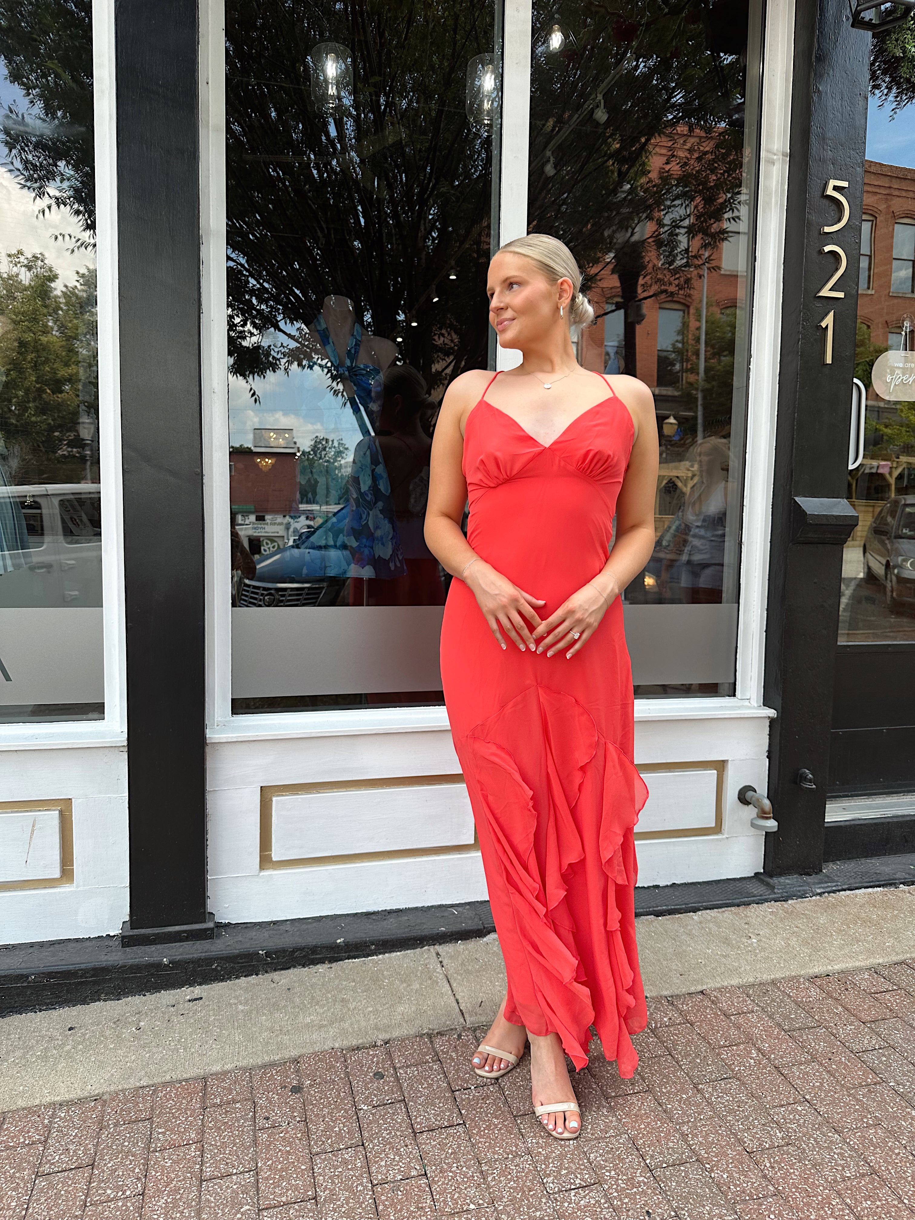 Coral maxi dress with ruffle detail and lace up back.