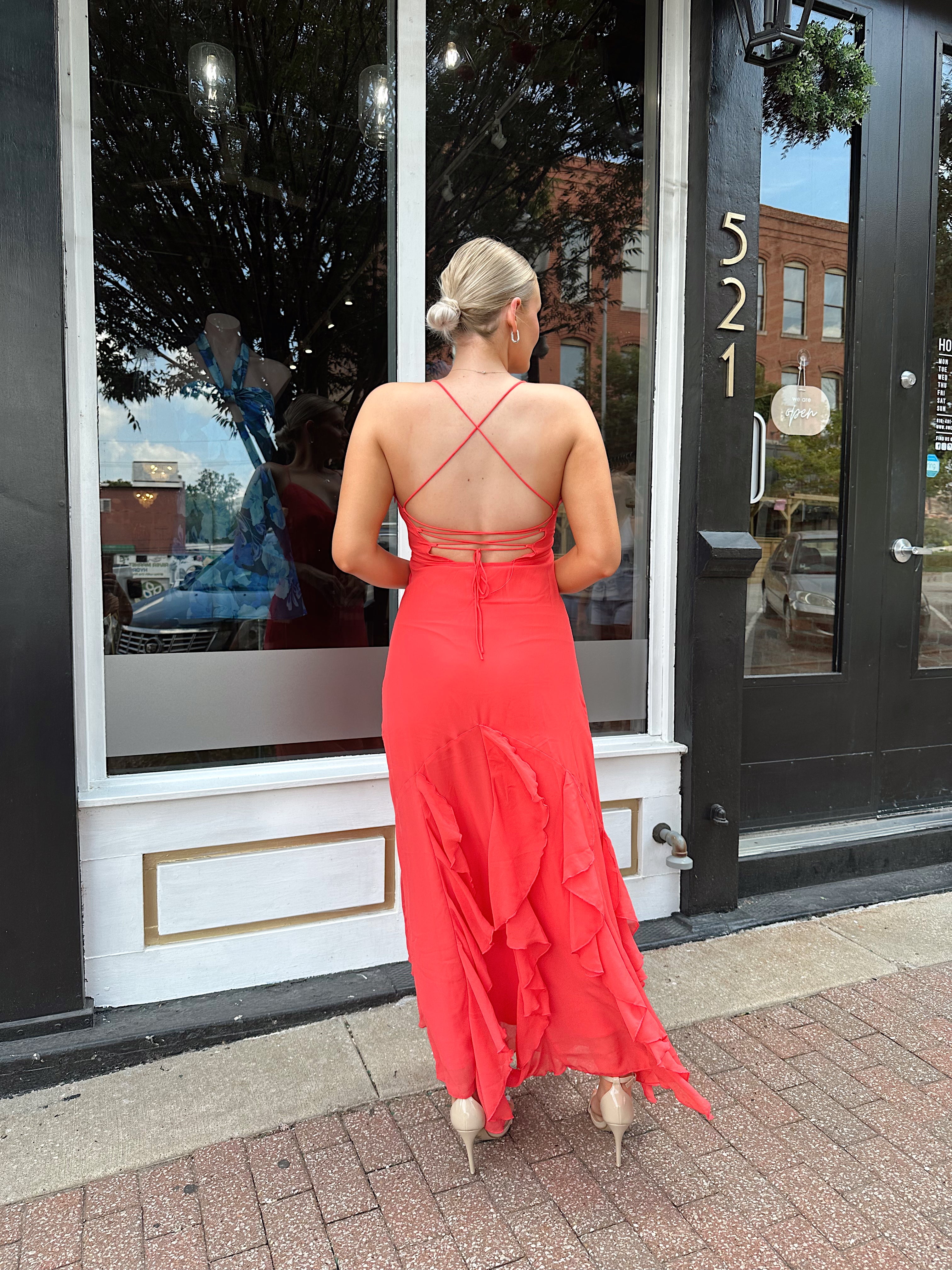 Coral maxi dress with ruffle detail and lace up back.