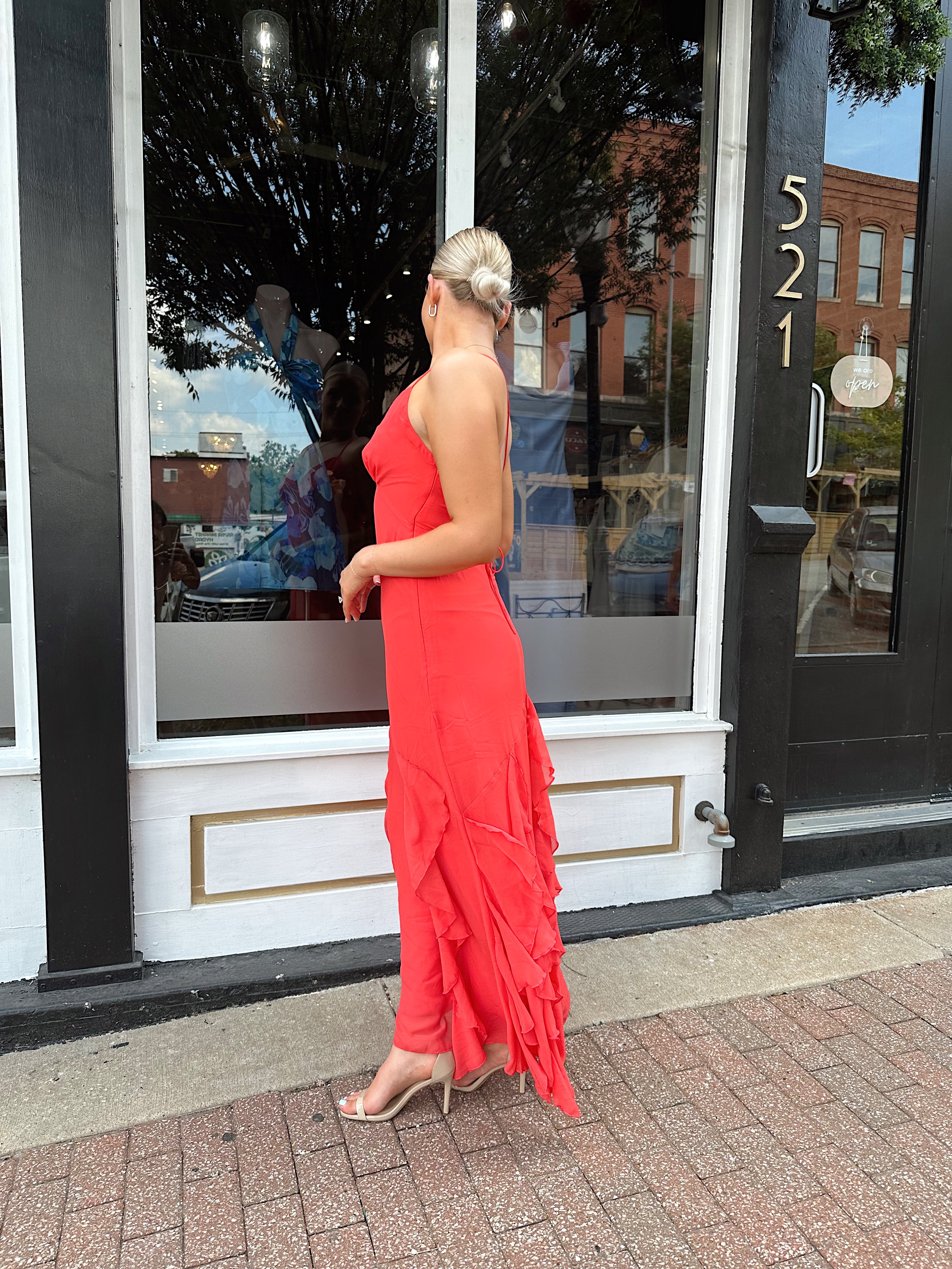 Coral maxi dress with ruffle detail and lace up back.
