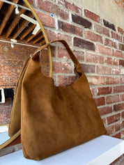 Camel suede shoulder bag with magnetic closure. 