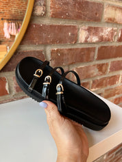 Billini Lacy Black Sandal with slim straps, gold buckles, and a cushioned sole for a modern, stylish, and comfortable fit