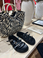 Billini Lacy Black Sandal with slim straps, gold buckles, and a cushioned sole for a modern, stylish, and comfortable fit