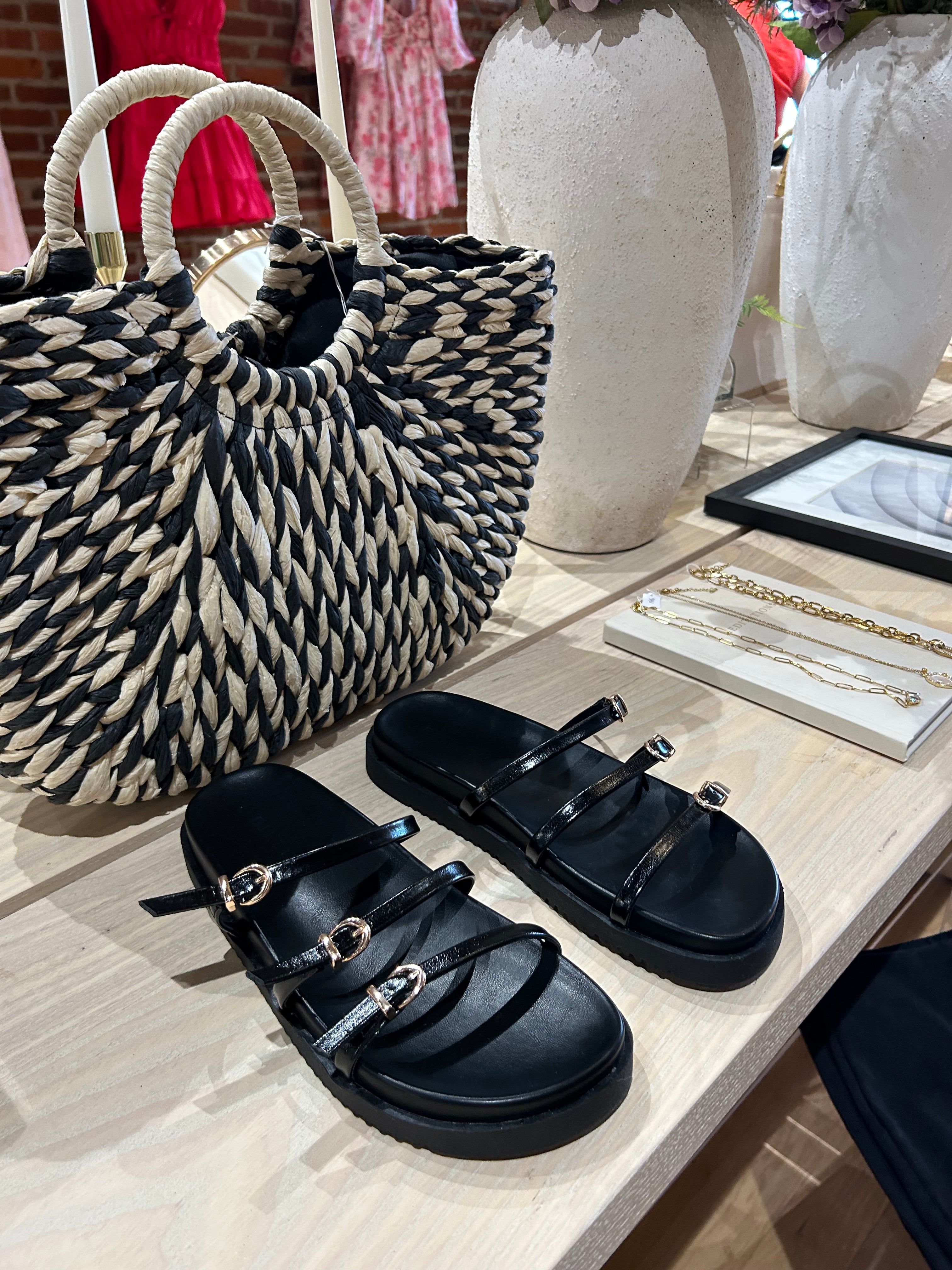 Billini Lacy Black Sandal with slim straps, gold buckles, and a cushioned sole for a modern, stylish, and comfortable fit