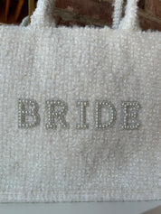 Bride Tweed Tote Bag with pearl-embellished lettering, soft textured fabric, and durable handles for a stylish bridal look.