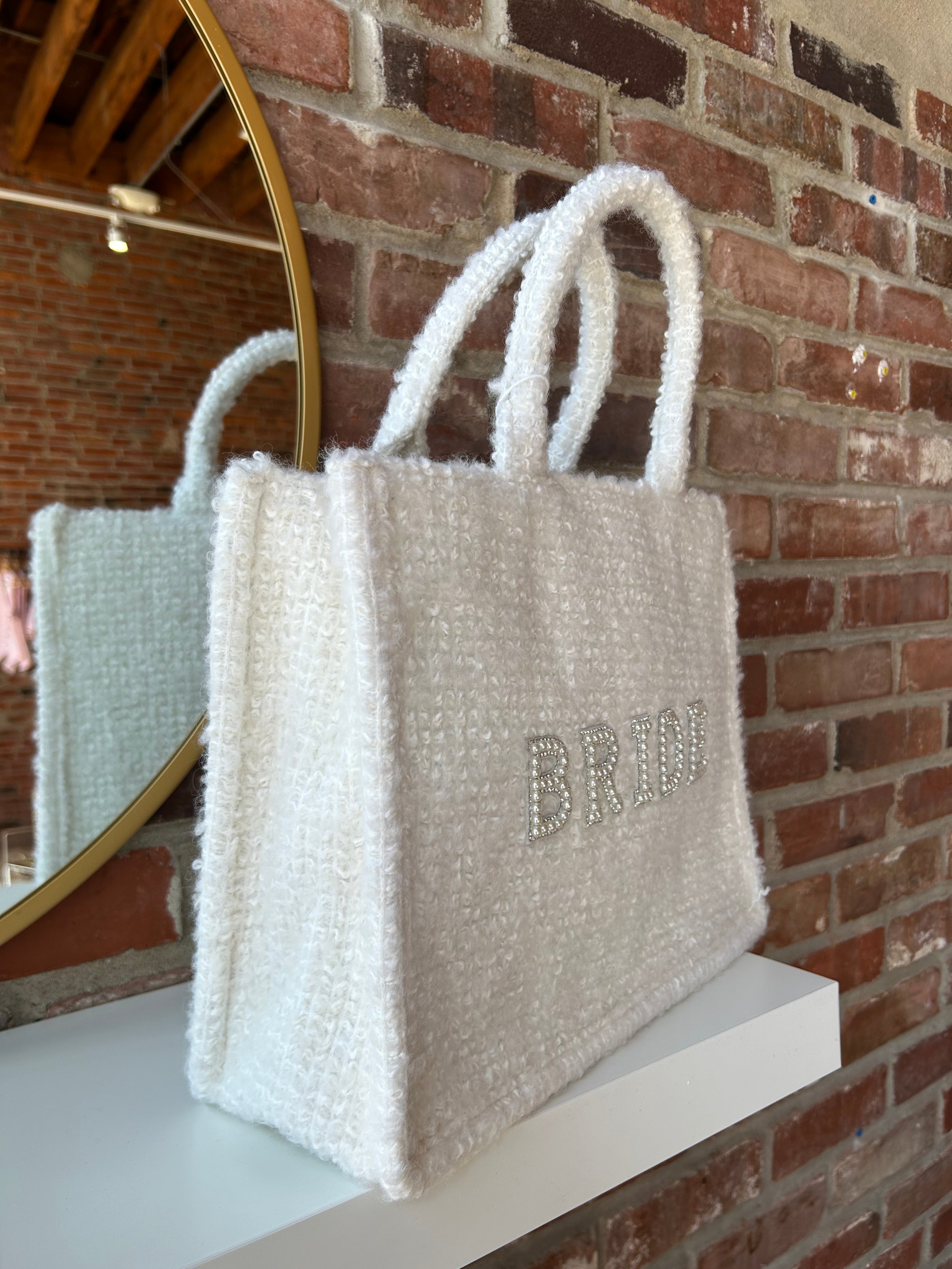 Bride Tweed Tote Bag with pearl-embellished lettering, soft textured fabric, and durable handles for a stylish bridal look.
