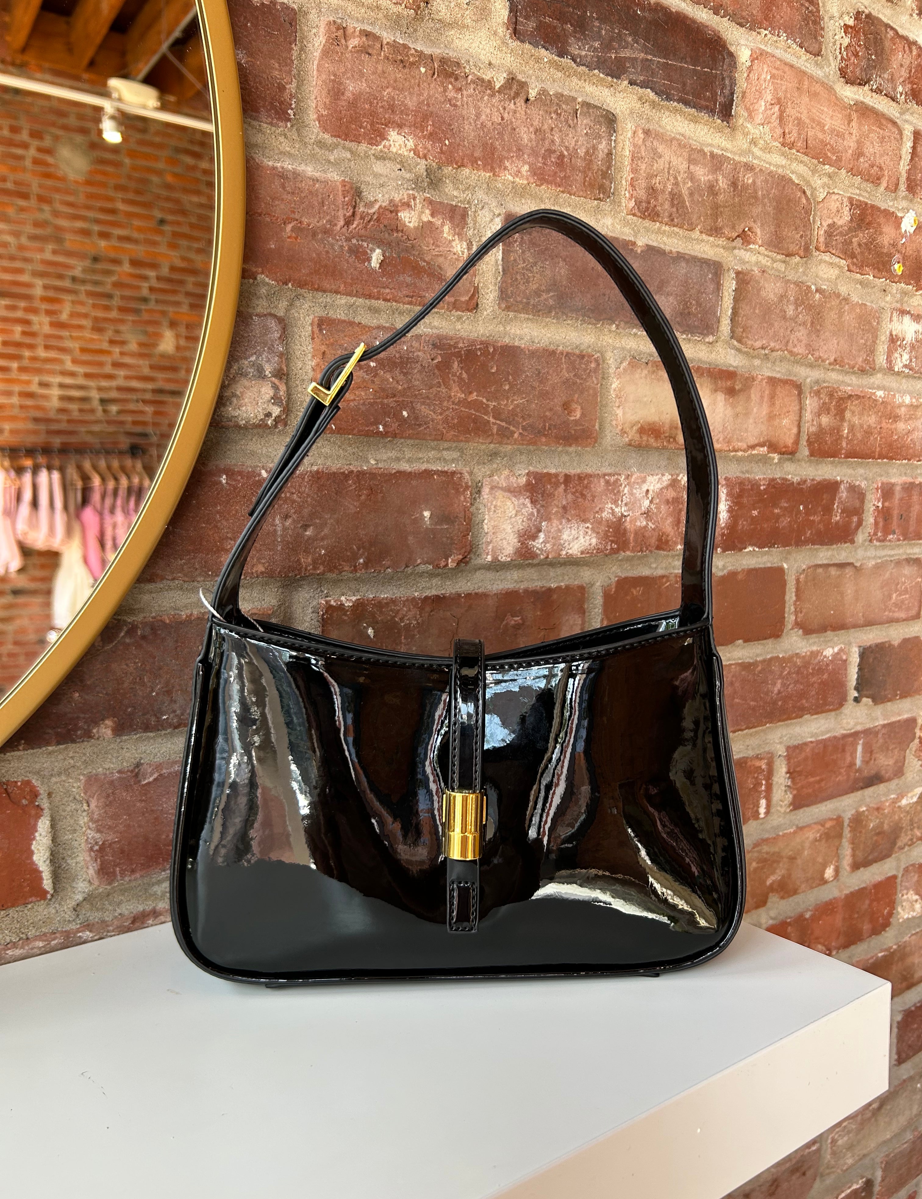 Black patent leather shoulder bag with gold hardware. Perfect for everyday use