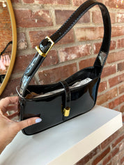 Black patent leather shoulder bag with gold hardware. Perfect for everyday use