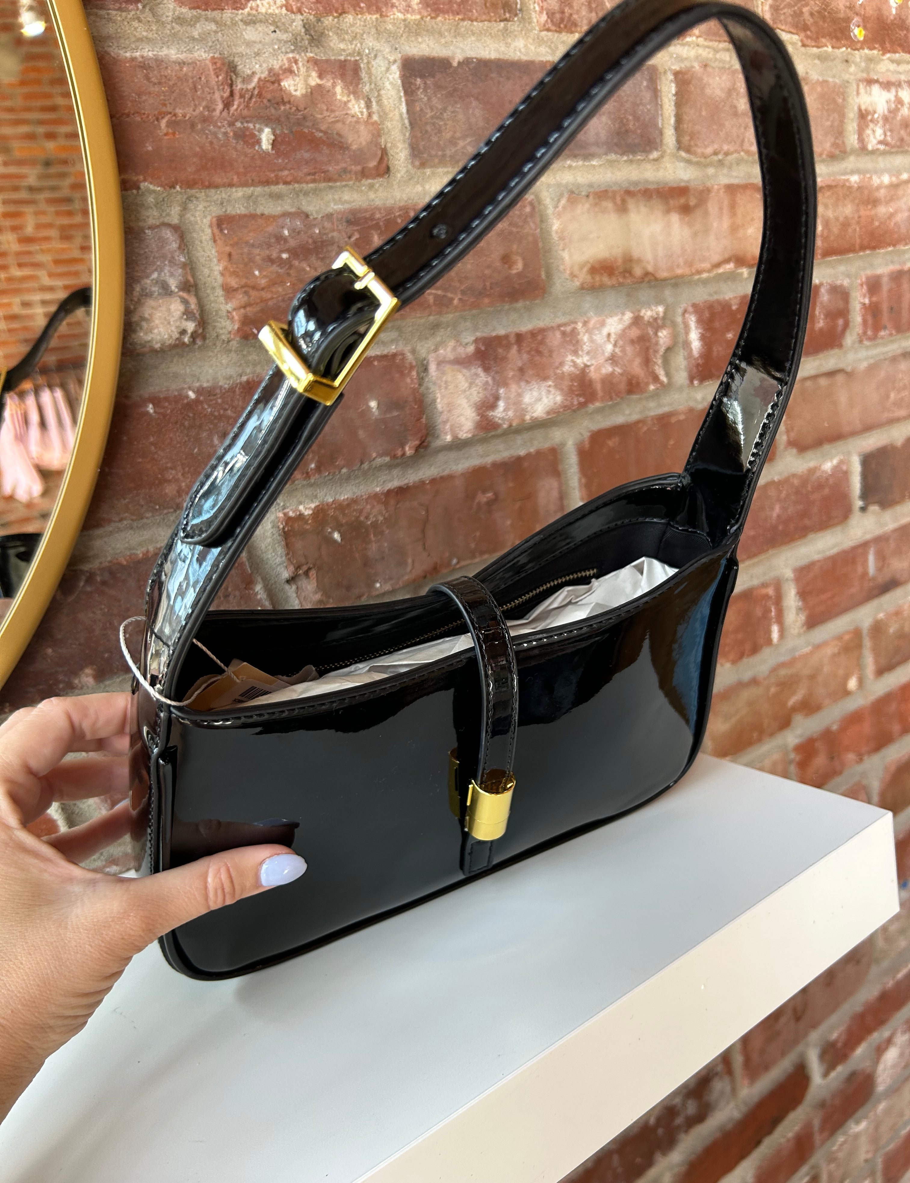 Black patent leather shoulder bag with gold hardware. Perfect for everyday use