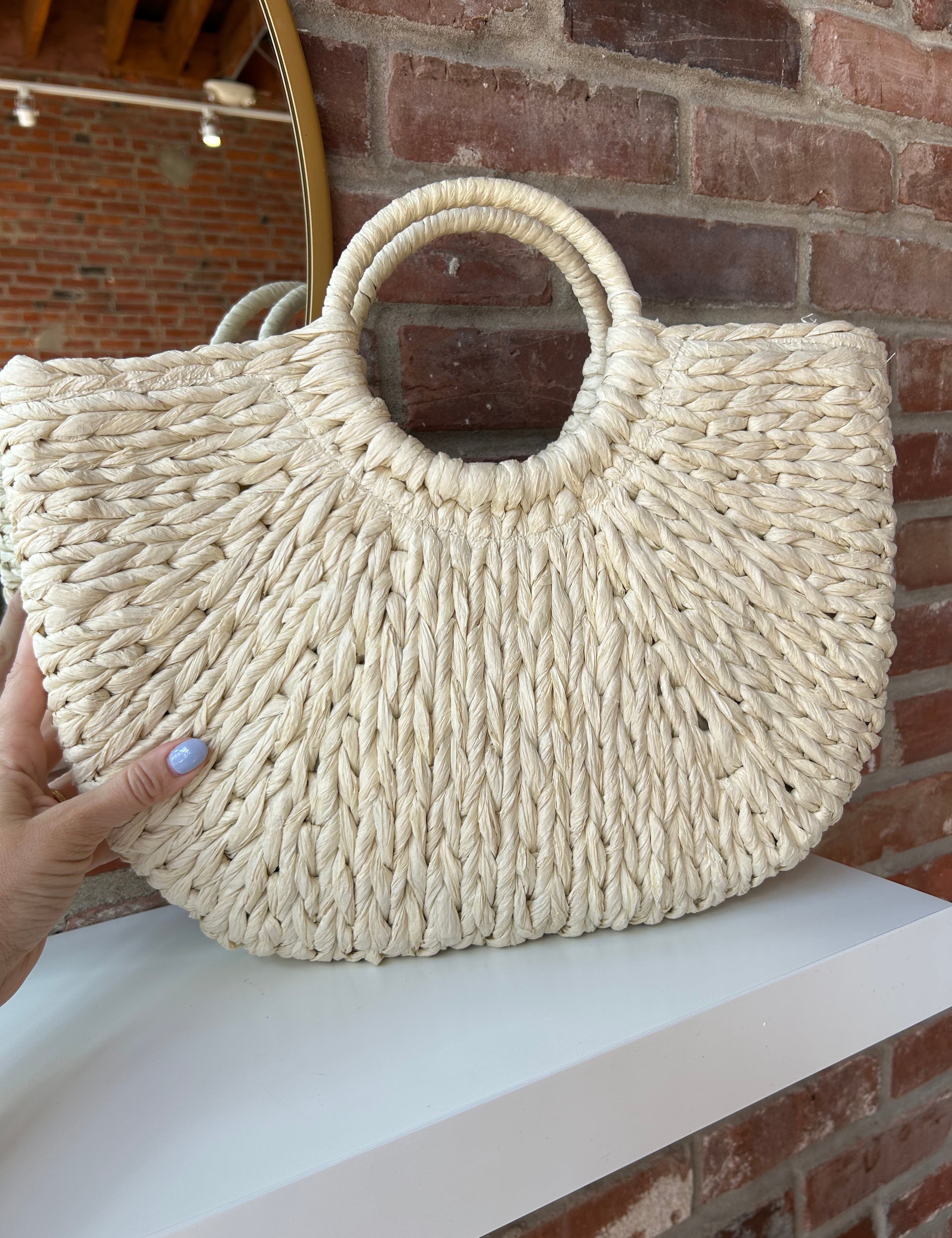 Beige straw woven tote bag. Perfect for vacation or carrying all summer. 