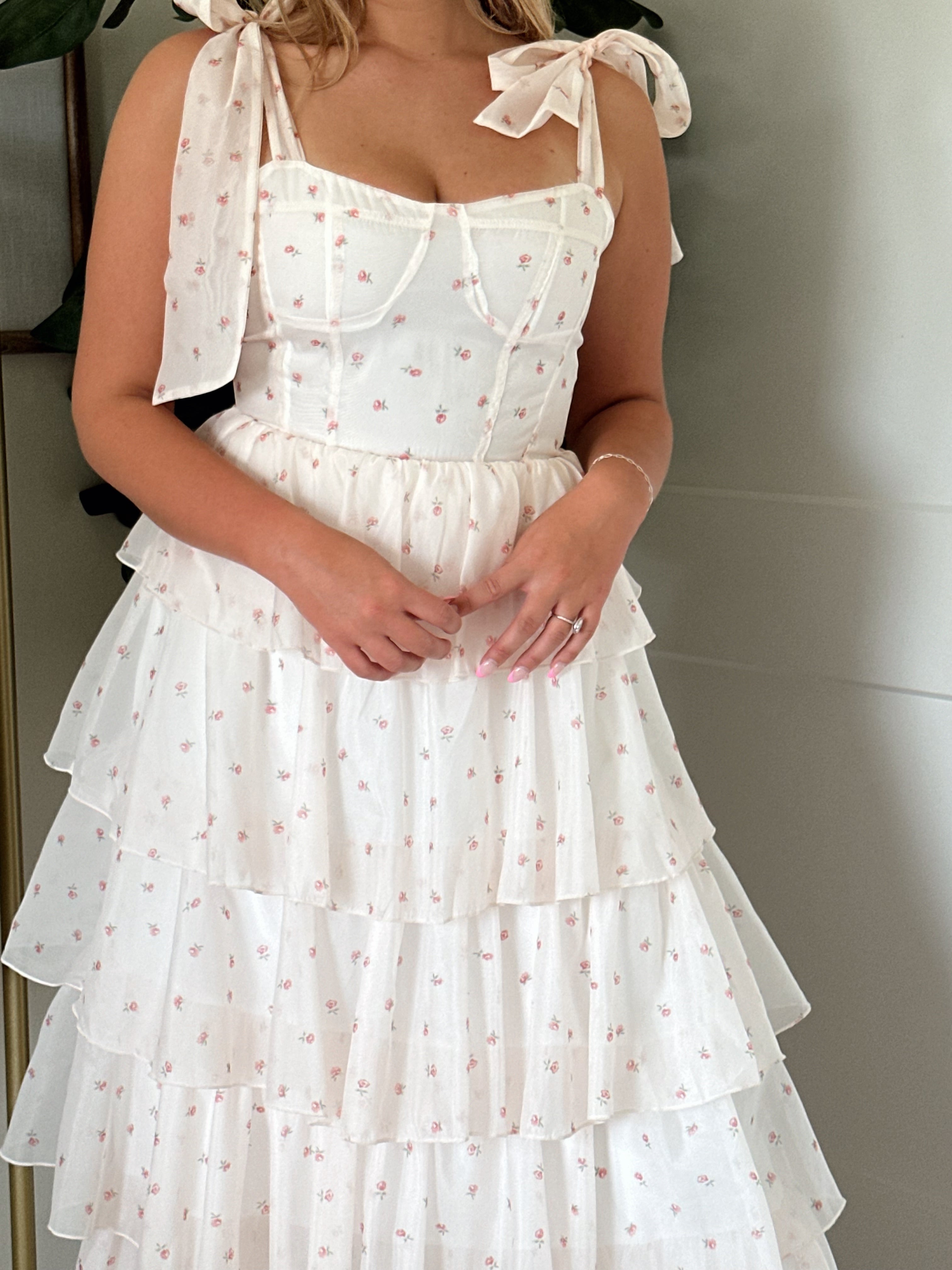 Light pink floral tiered midi dress with self tie straps.