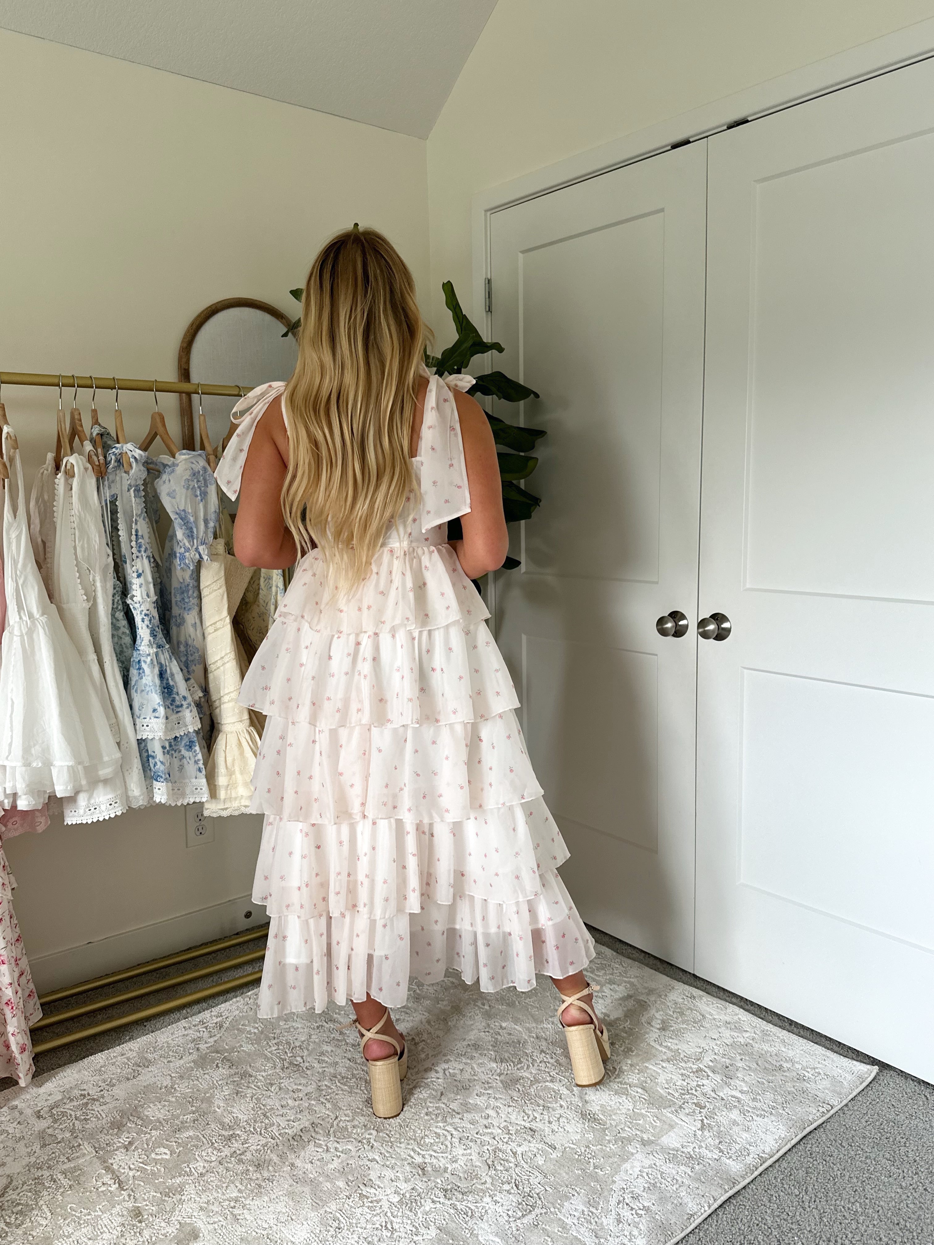 Light pink floral tiered midi dress with self tie straps.