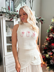 Woman wearing ivory asymmetrical maxi skirt with plated bottom.