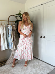 Pink floral ruffled midi dress with spaghetti straps and tiered hem
