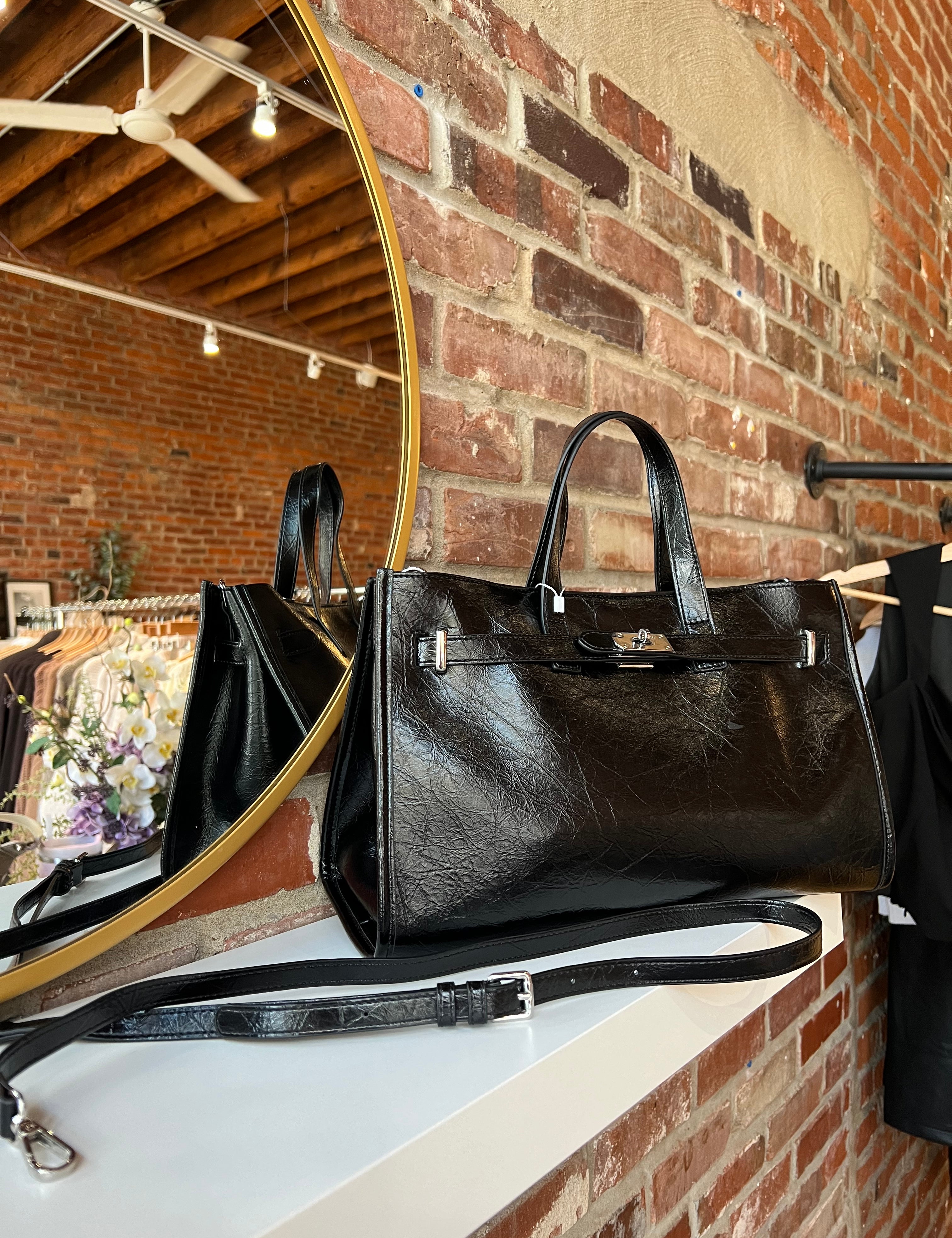 Jetta Black Leather Tote Bag with structured shape, top handles, and matching removable inner pouch